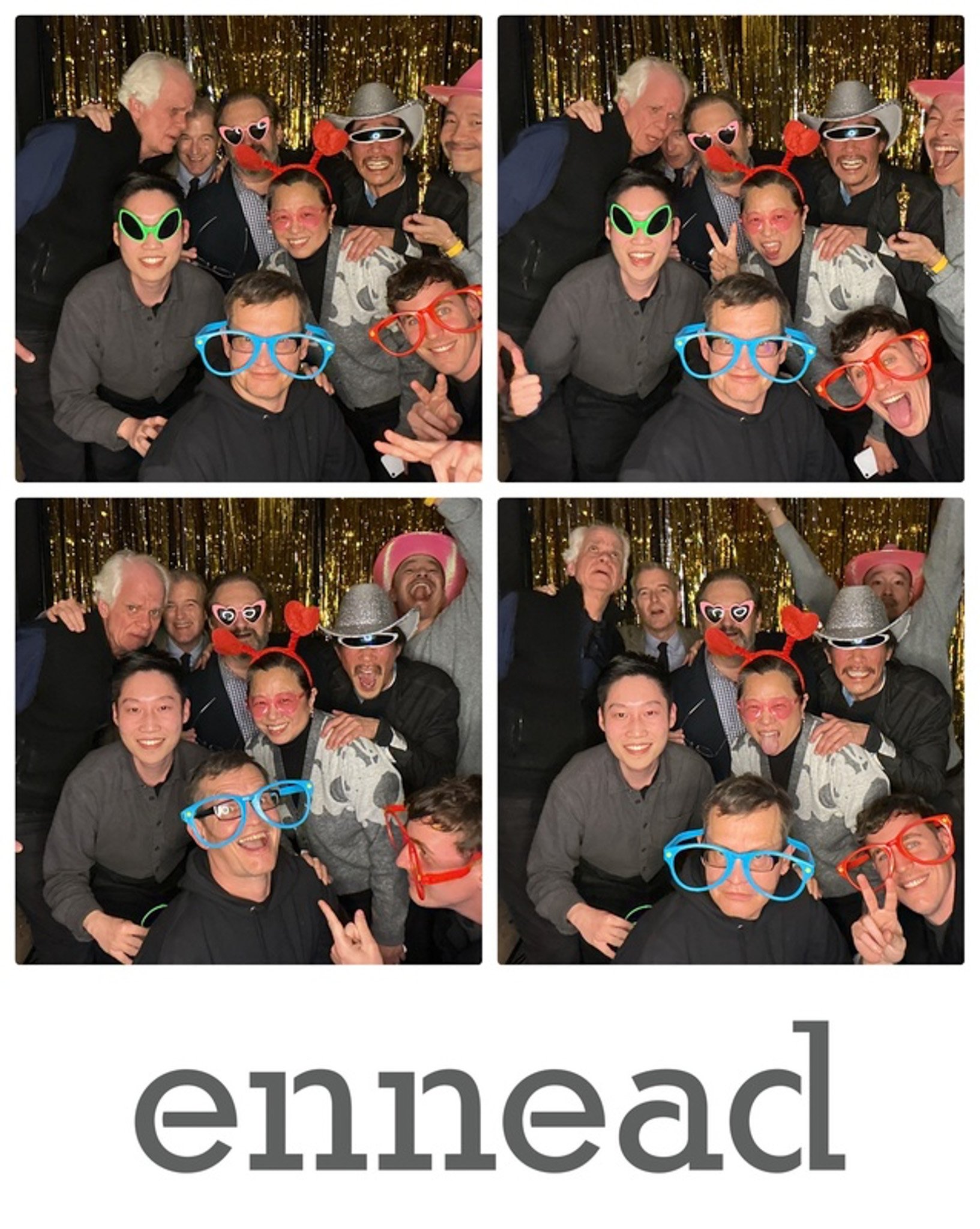 Group photo of people wearing playful costumes and large glasses against a gold backdrop, with the text "ennead" below.