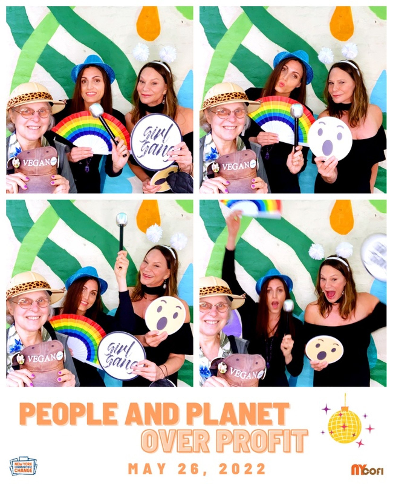 Group of three women posing in a photo booth with props including a rainbow fan, "Girl Gang" sign, and "VEGAN" cap. The background features colorful abstract patterns. Text reads "People and Planet Over Profit May 26, 2022."