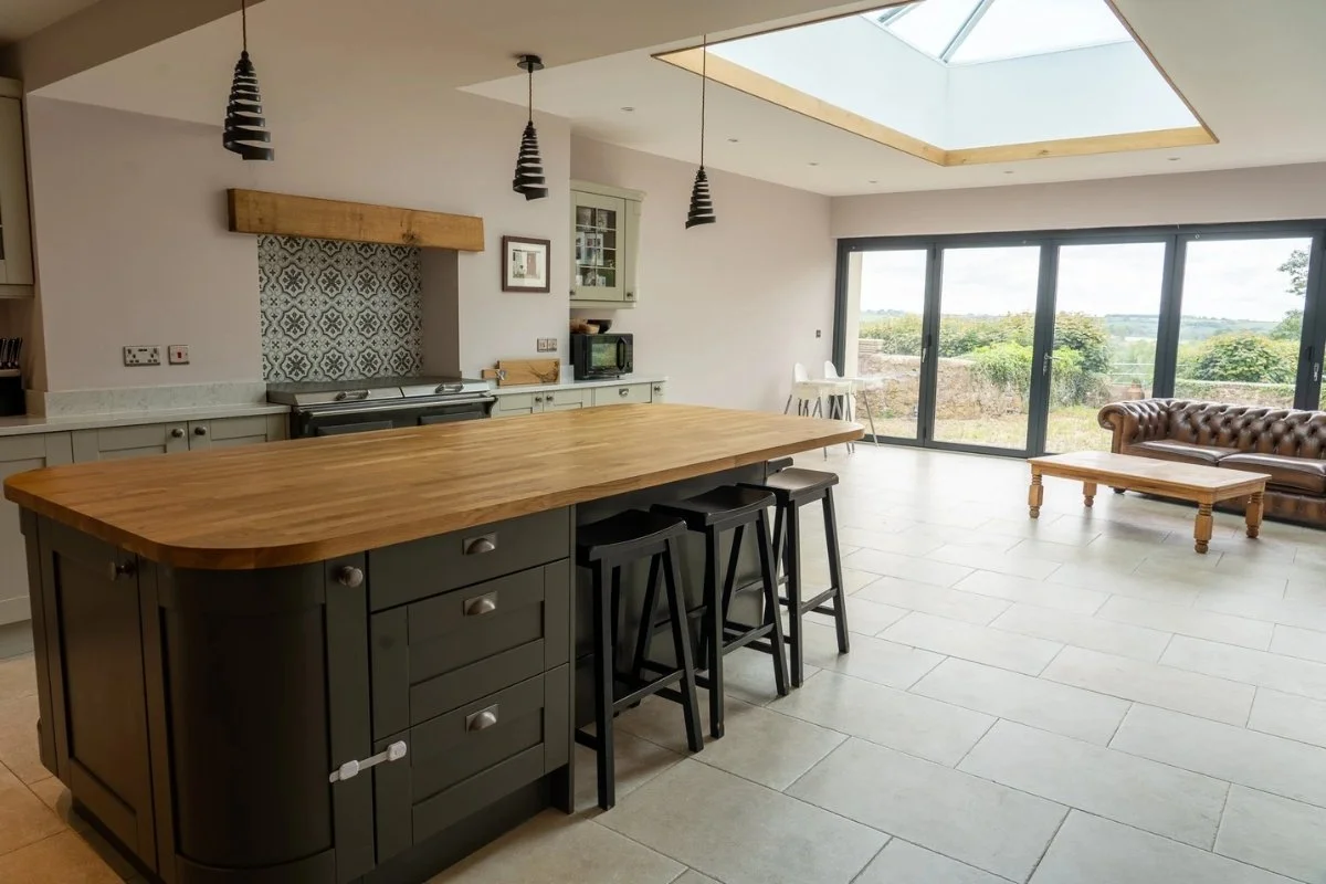 A curved style kitchen island with solid wood worktop.