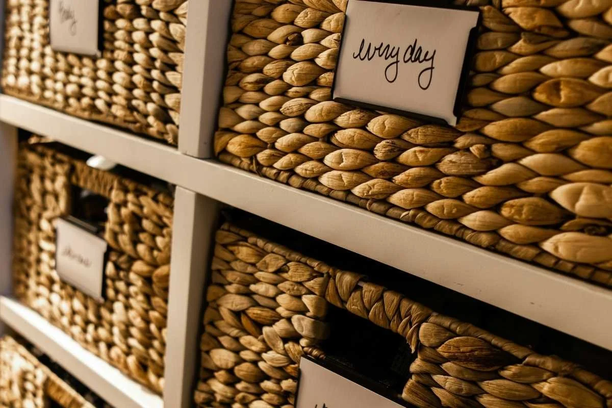 Storage baskets with labels on the front.