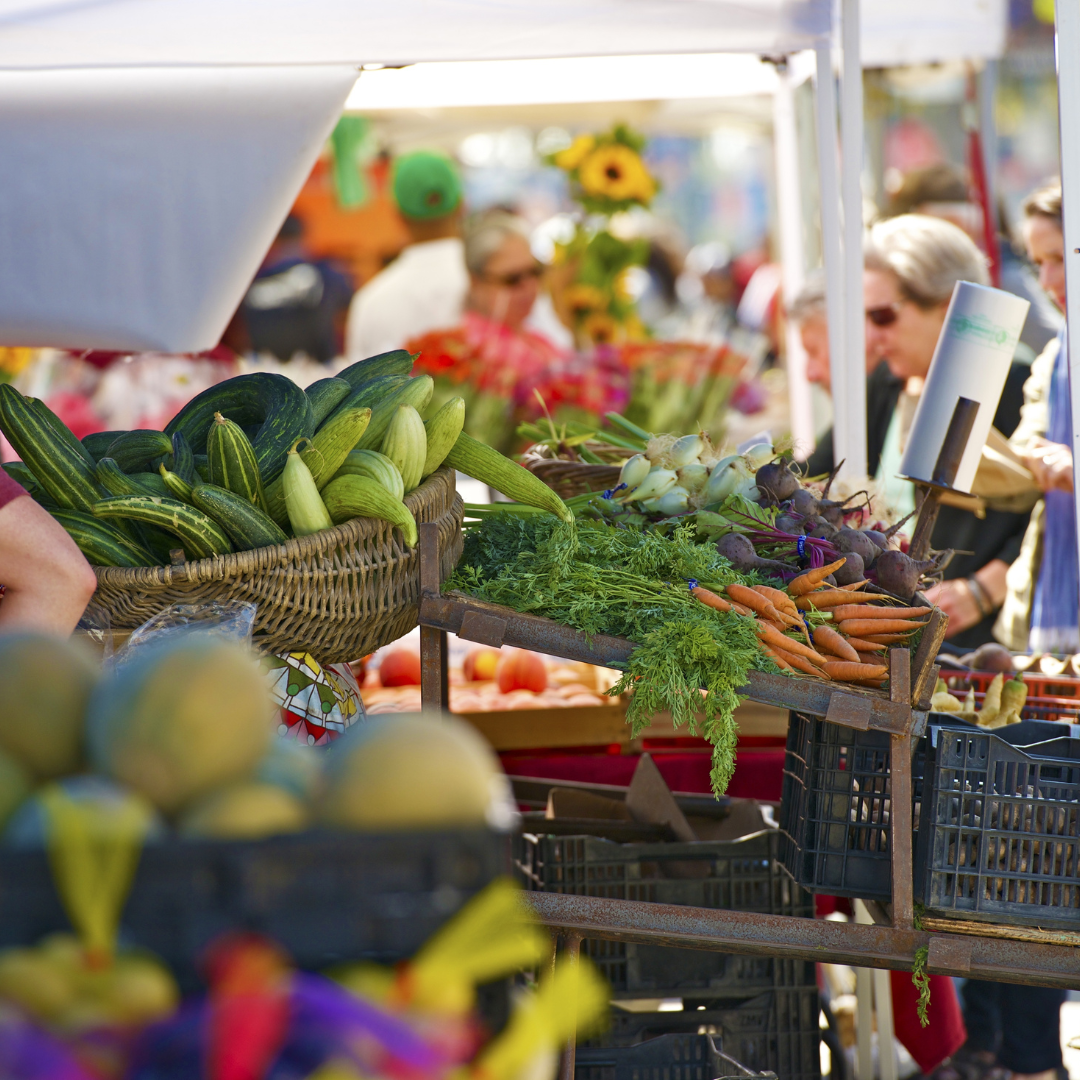 shelves of fresh vegetables at farmers market