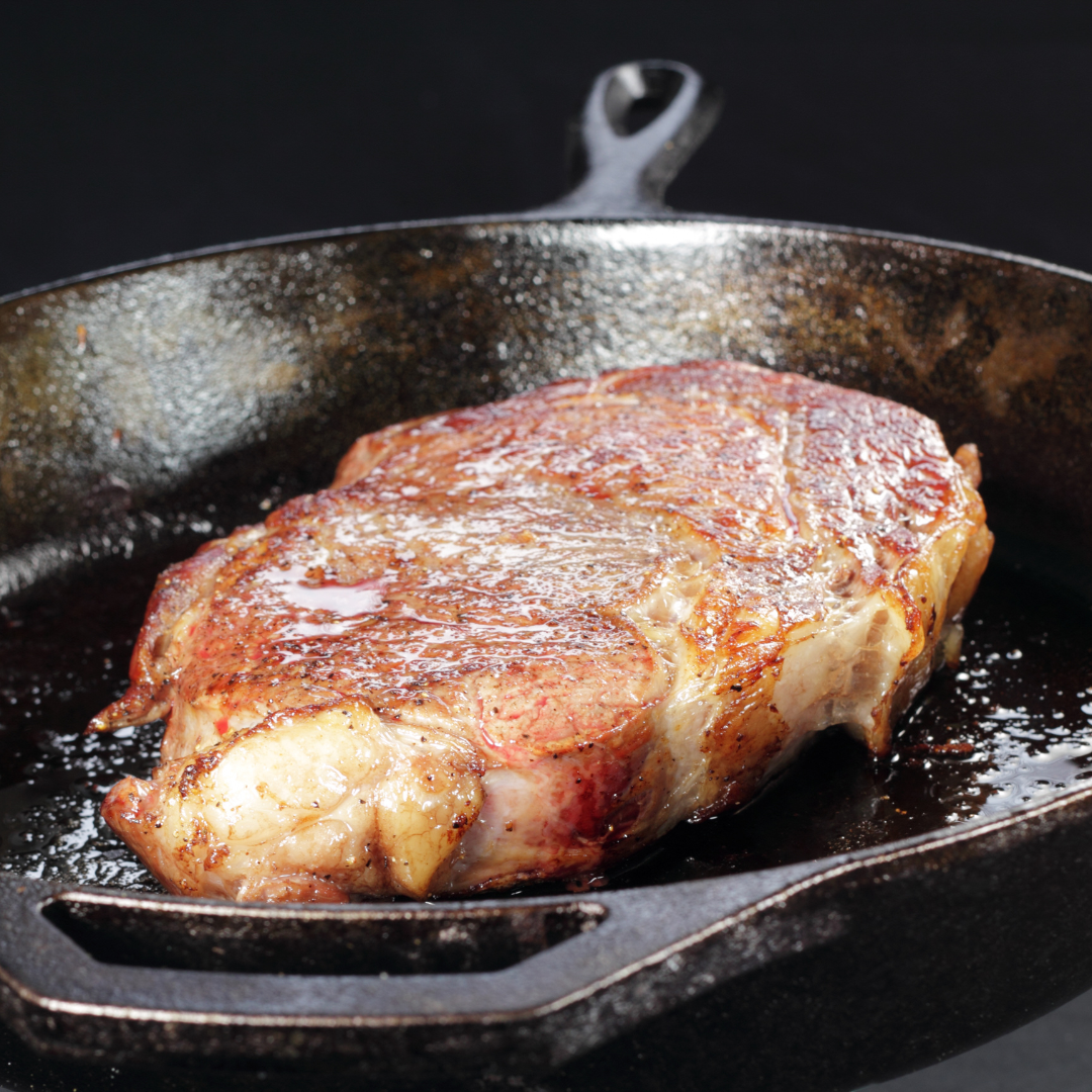 steak searing in cast iron pan