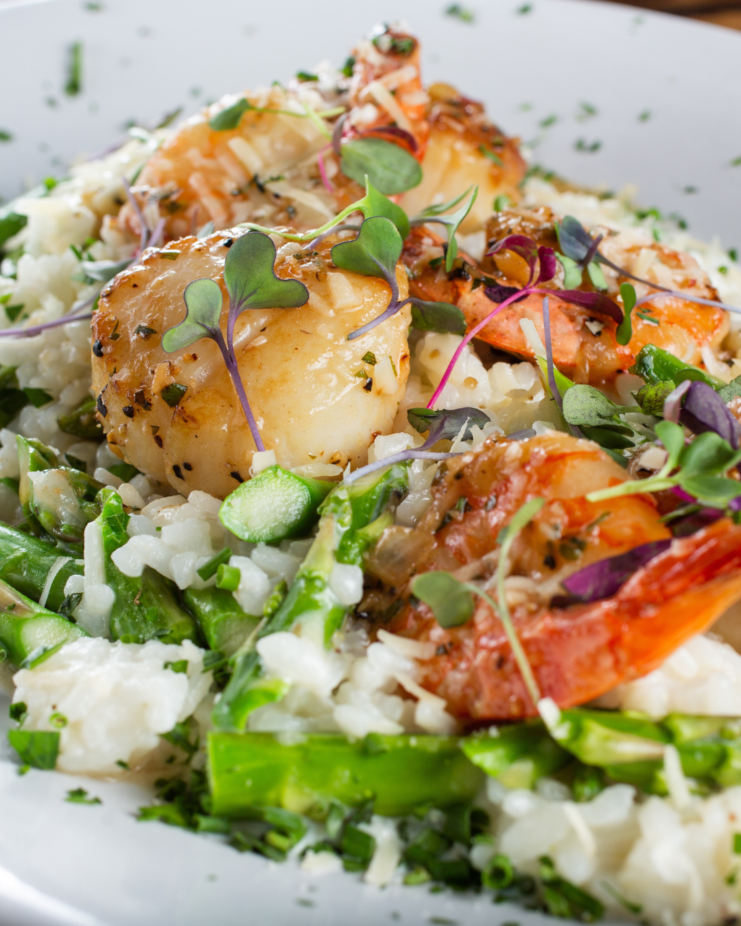 Scallop and shrimp risotto with asparagus and peas