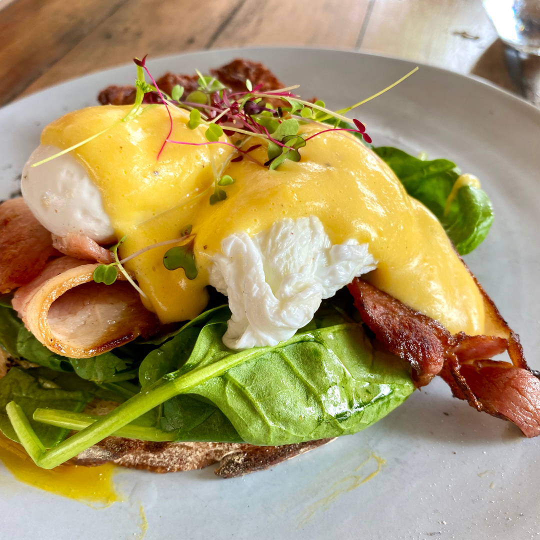eggs benedict with sliced turkey, bacon and spinach