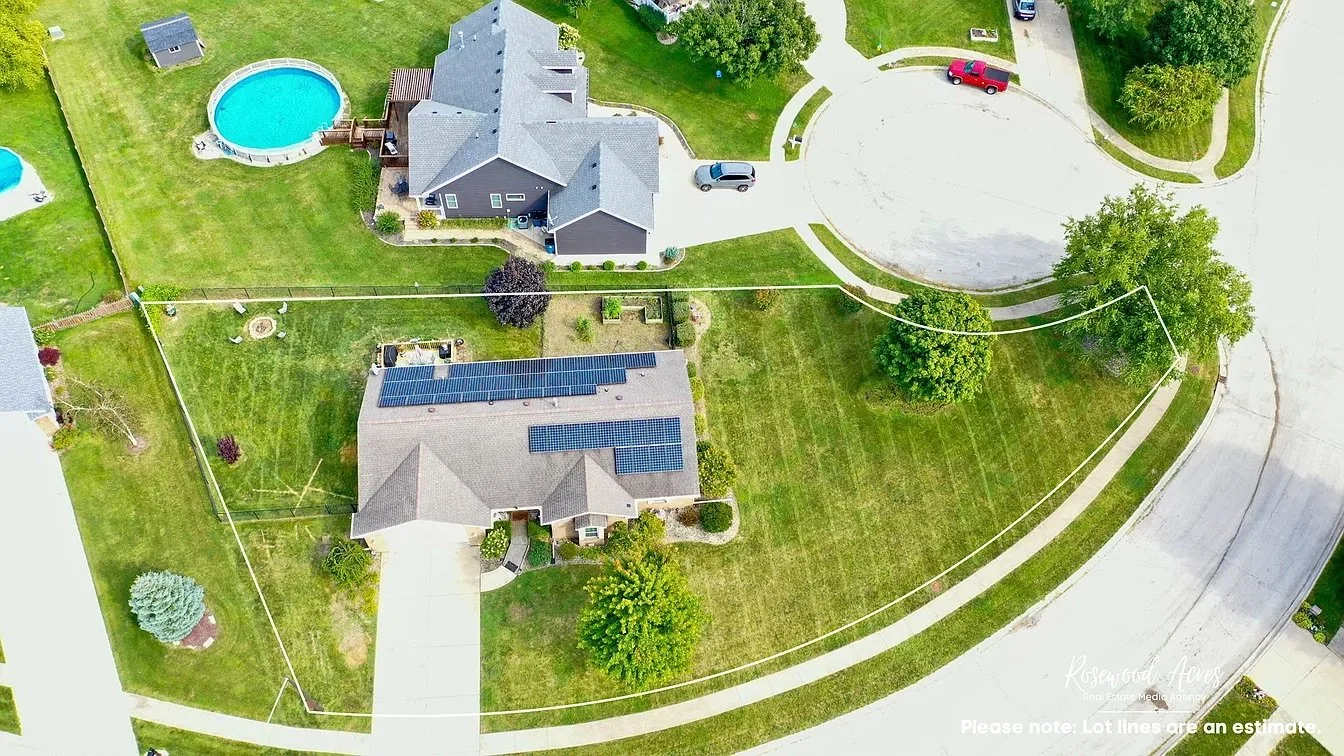 Aerial: Aerial view of a Bourbonnais corner property showing the front and backyard lawns maintained by the owner of The Lawn Care Company.
