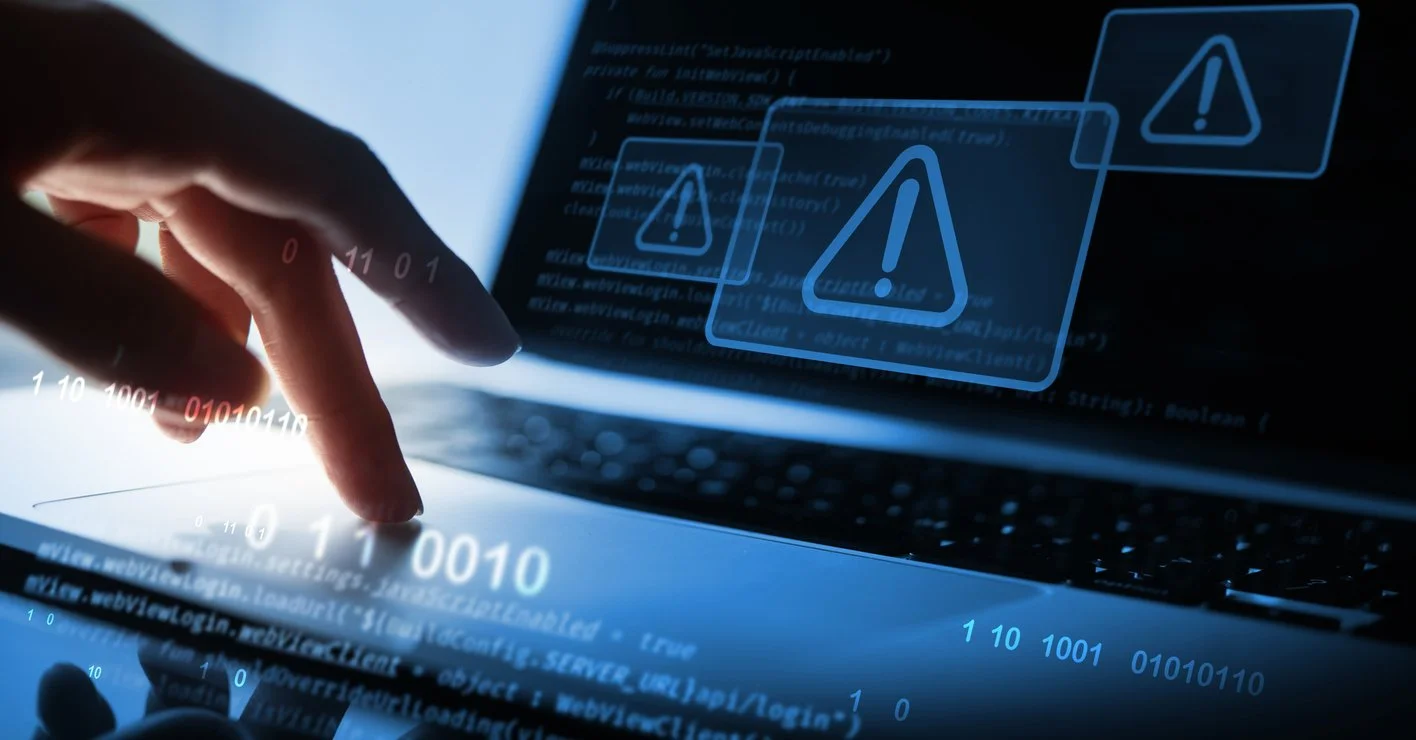 bilde av en hånd på en datamaskin under cyberangrep