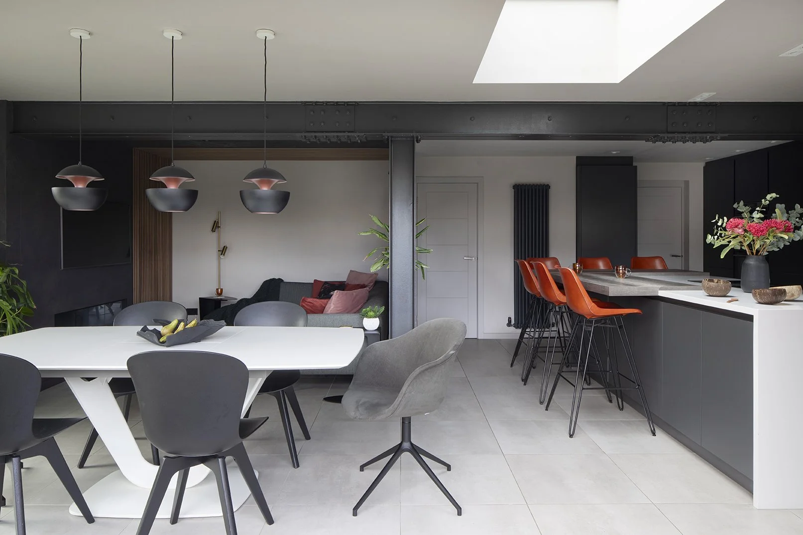 Wide view of open-plan extension showing dining table, kitchen island with orange leather bar stools and copper pendant lights, Lytham Road Tynemouth