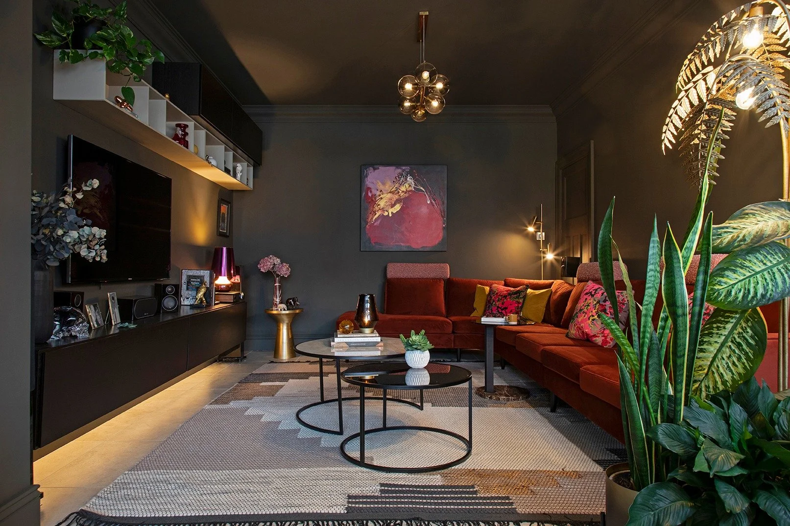 This is the room that holds the day and softens the night.

In daylight it feels calm and grounded, a quiet anchor at the heart of our home. At night it really comes into its own. The dark walls deepen, the lamplight glows and the rich colours and te