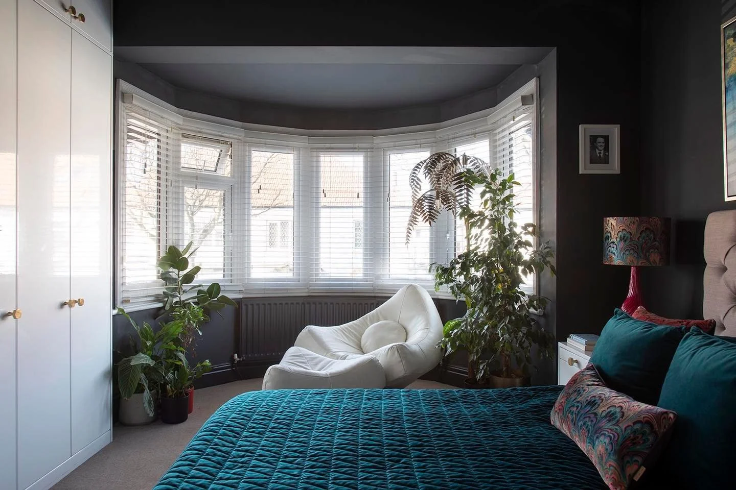 Soft winter light pours across this bay window, catching the plants and the curve of the chair. 

By late afternoon, this is where the whole room exhales.

When I designed this space, I wanted it to feel like a pause in the day, somewhere you can sit