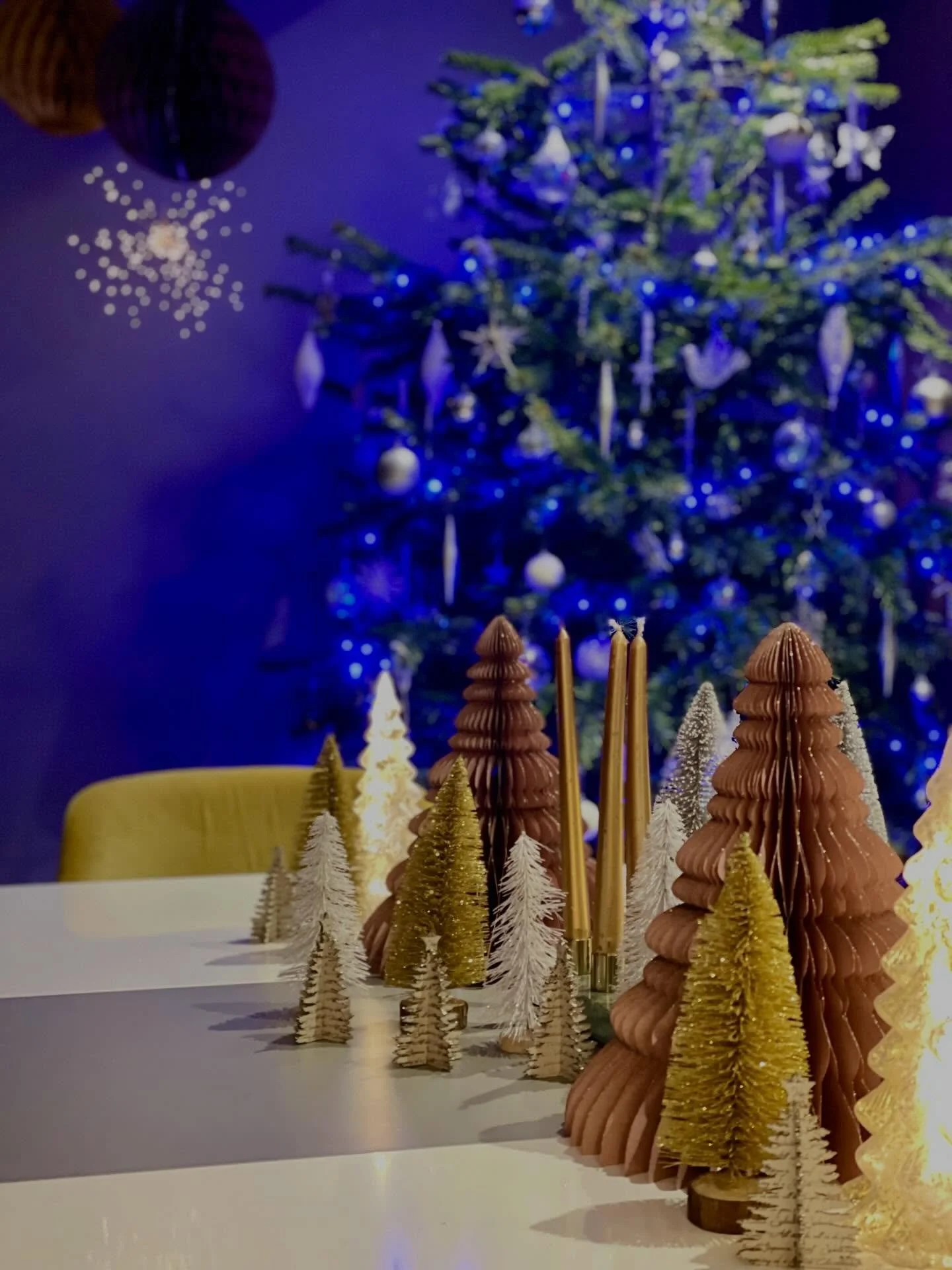Designing a festive table in our home was a little like tuning an instrument.

The space already carries a lot of energy.
Soft green walls, strong lines, an electric blue tree in the corner.
If I had simply layered more sparkle on top, it would have 