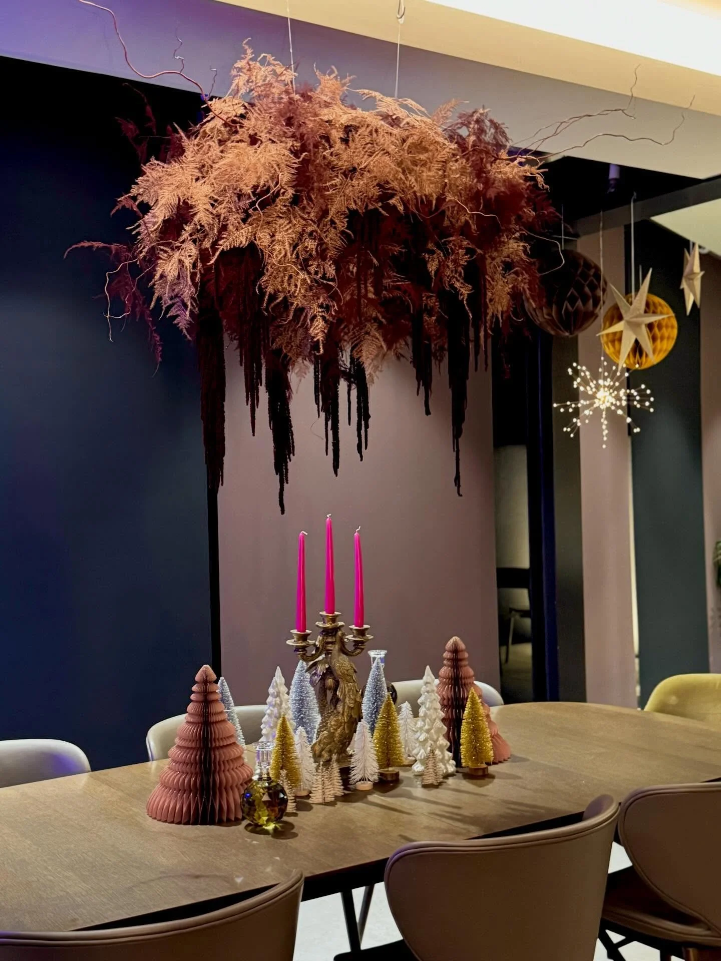 Blue tree lights in the corner, copper and burgundy fern cloud floating above, tiny forests gathered on the table. At night this room feels alive.

When I designed this space, I wanted it to hold both quiet and celebration. This year there will be no