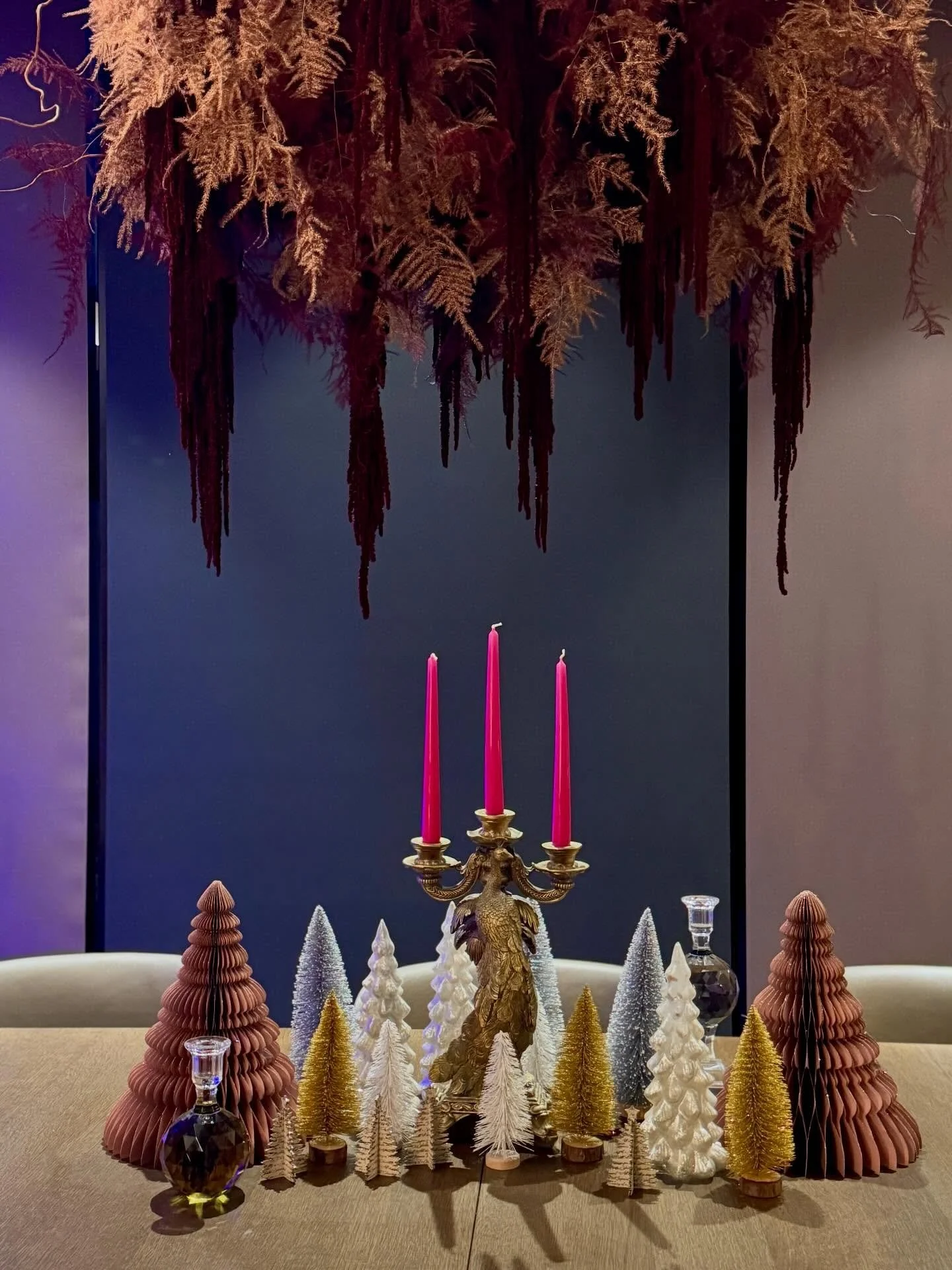 Christmas Eve, and this room feels ready.

Tree glowing in the corner. Fern cloud hovering above the table, copper and burgundy catching the light. Glasses lined up, little forests gathered, a quiet hum of &ldquo;something is coming&rdquo;.

This yea