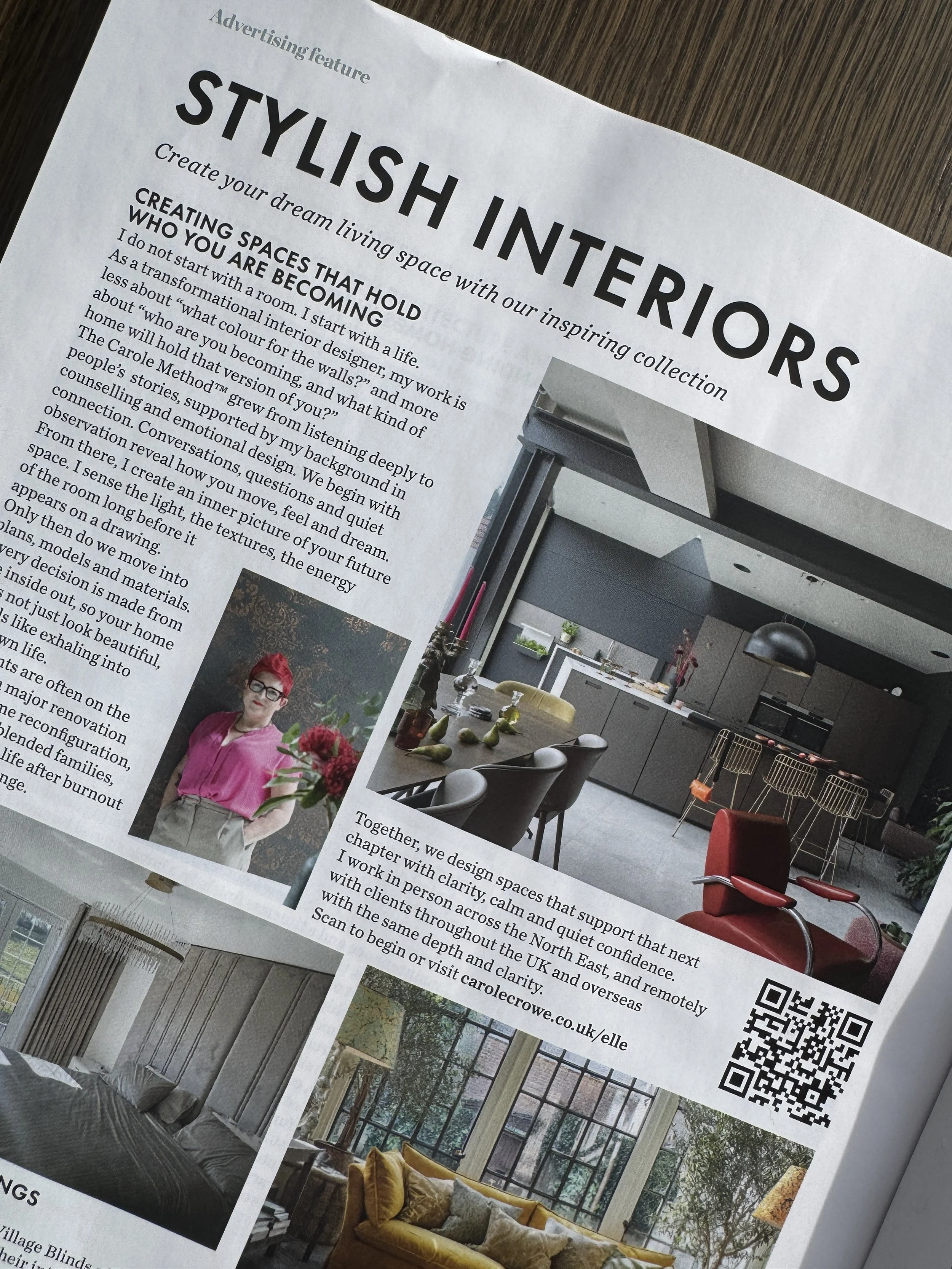 A newspaper advertisement page about stylish interiors, featuring a large photo of a modern kitchen and dining area, a smaller photo of a woman with short red hair and glasses, and a QR code.