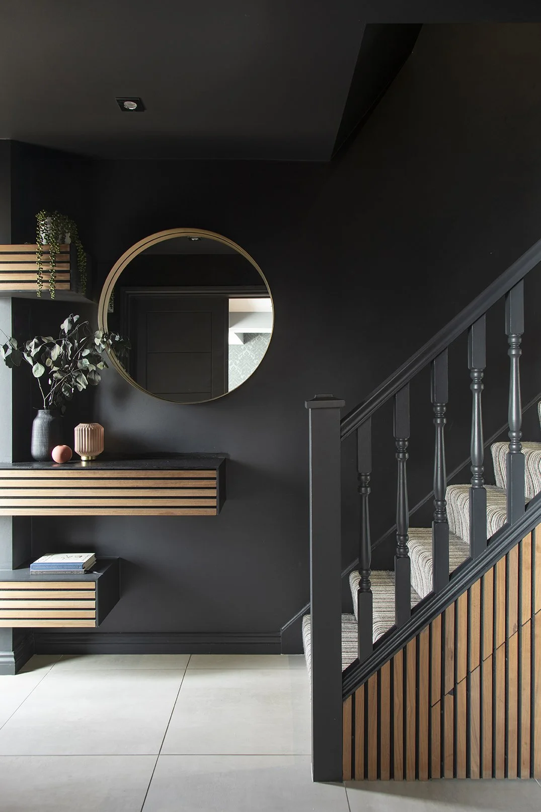  Bespoke slatted wood hallway shelving with round brass mirror, dark walls and striped stair carpet, Lytham Road Whitley Bay