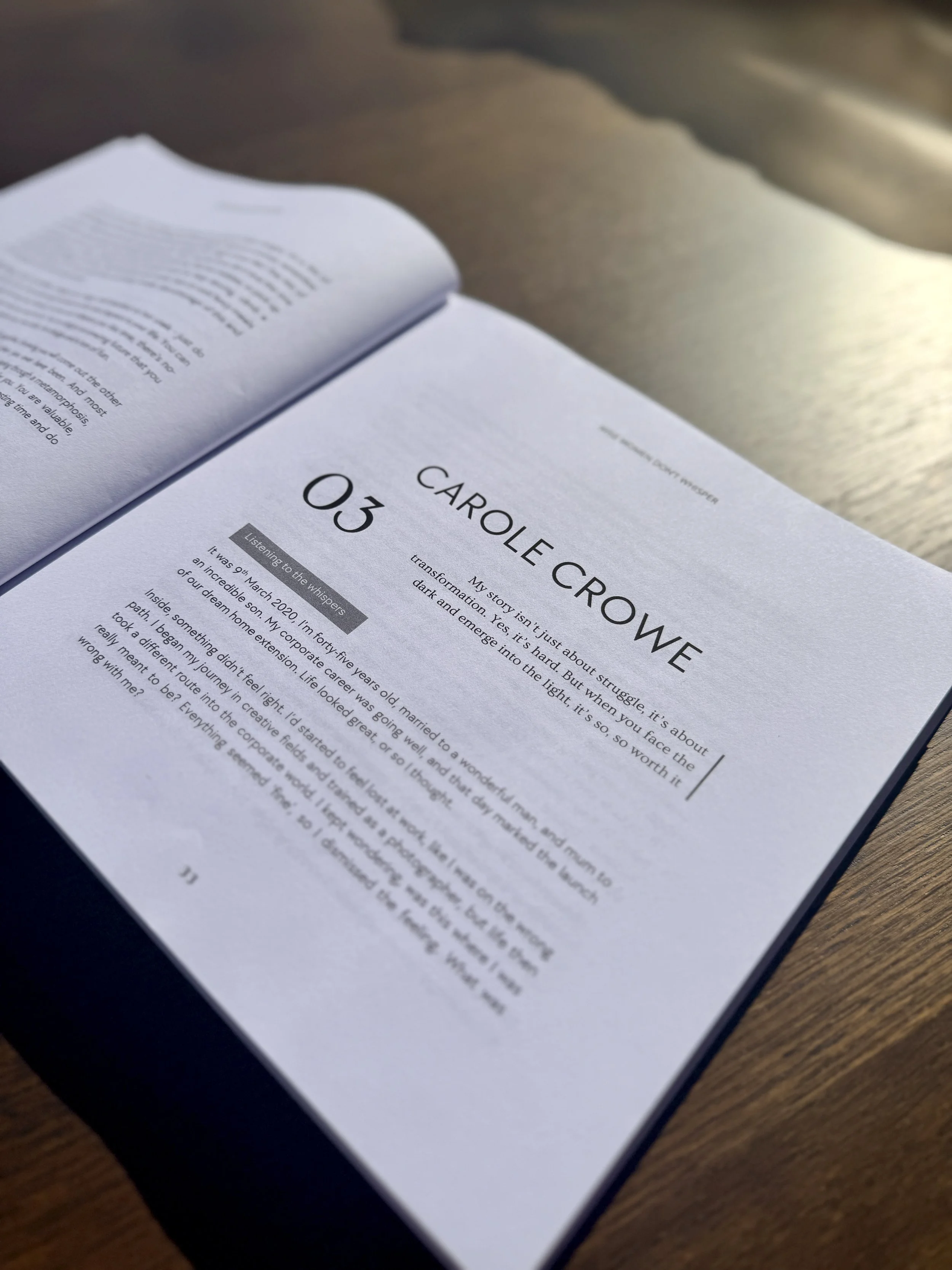 Open book on a wooden surface showing a chapter titled 'Carole Crowe' with the number '03' and a paragraph of text.