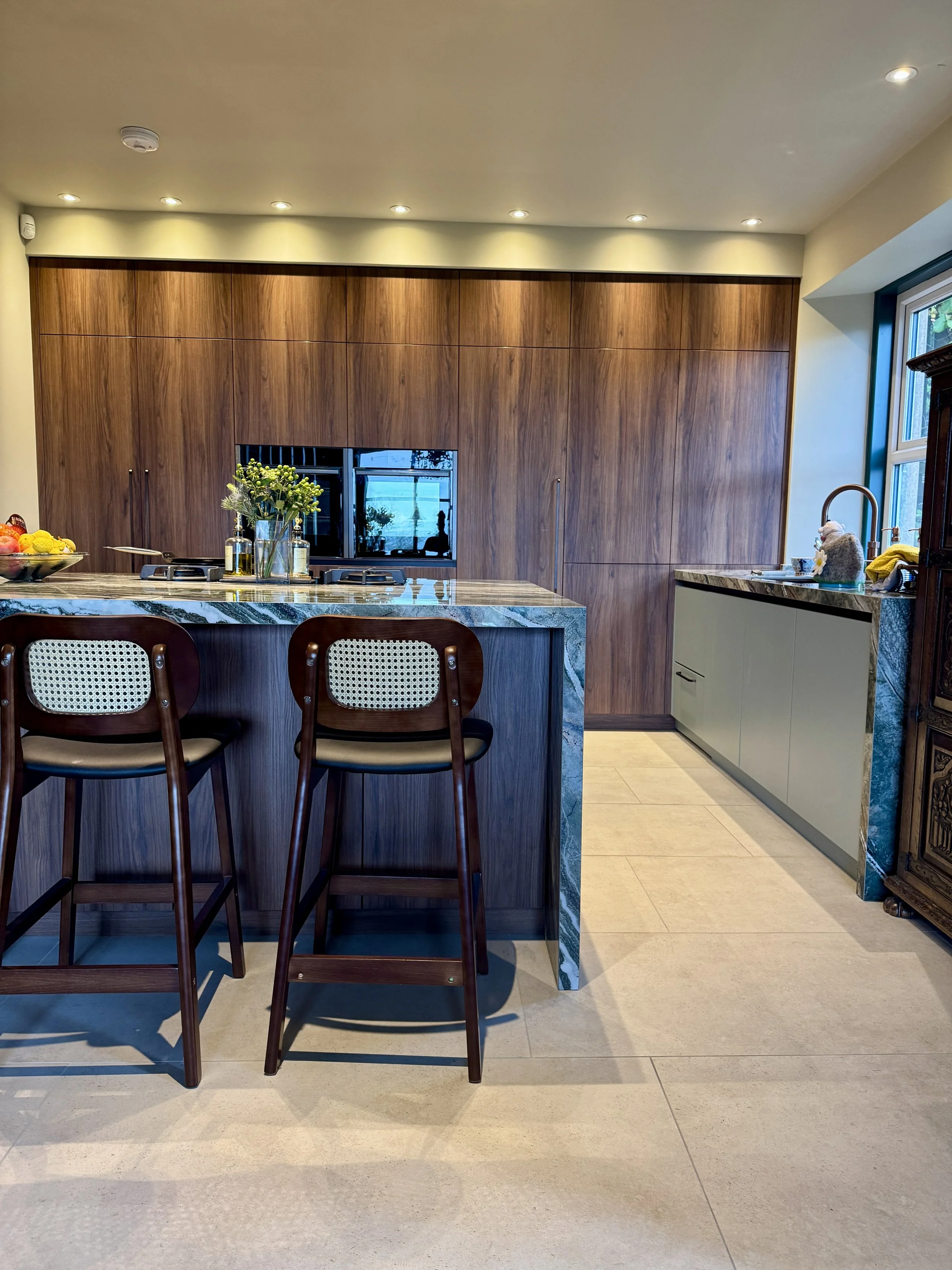 county-durham-kitchen-island-and-walnut-cabinetry-feature-worktop-infinity-peacock-worksurface.JPG