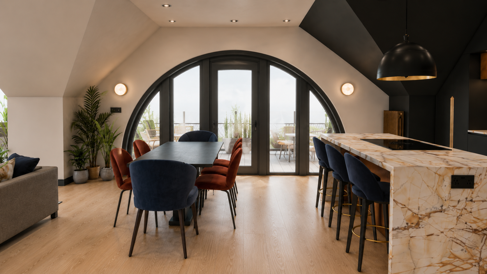 Interior design visual of the open-plan kitchen and dining area at Clements Wharf, Durham, by Carole Crowe Interior Design, showing a large black dining table with navy blue and burnt orange velvet upholstered chairs, a dramatic curved black arched g