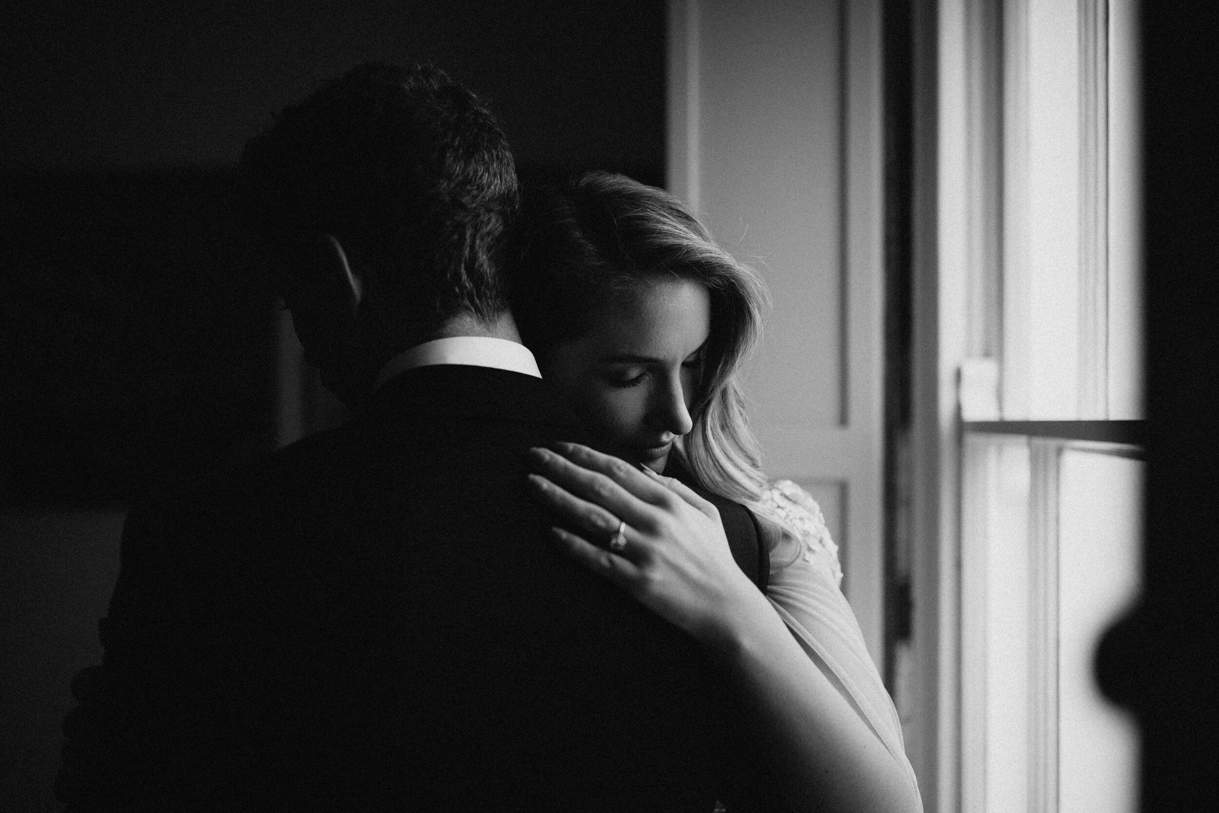 Male model Matt Sharman holds female model Lara wearing a black tuxedo, white shirt and black bow tie for Fern Godfrey Weddings