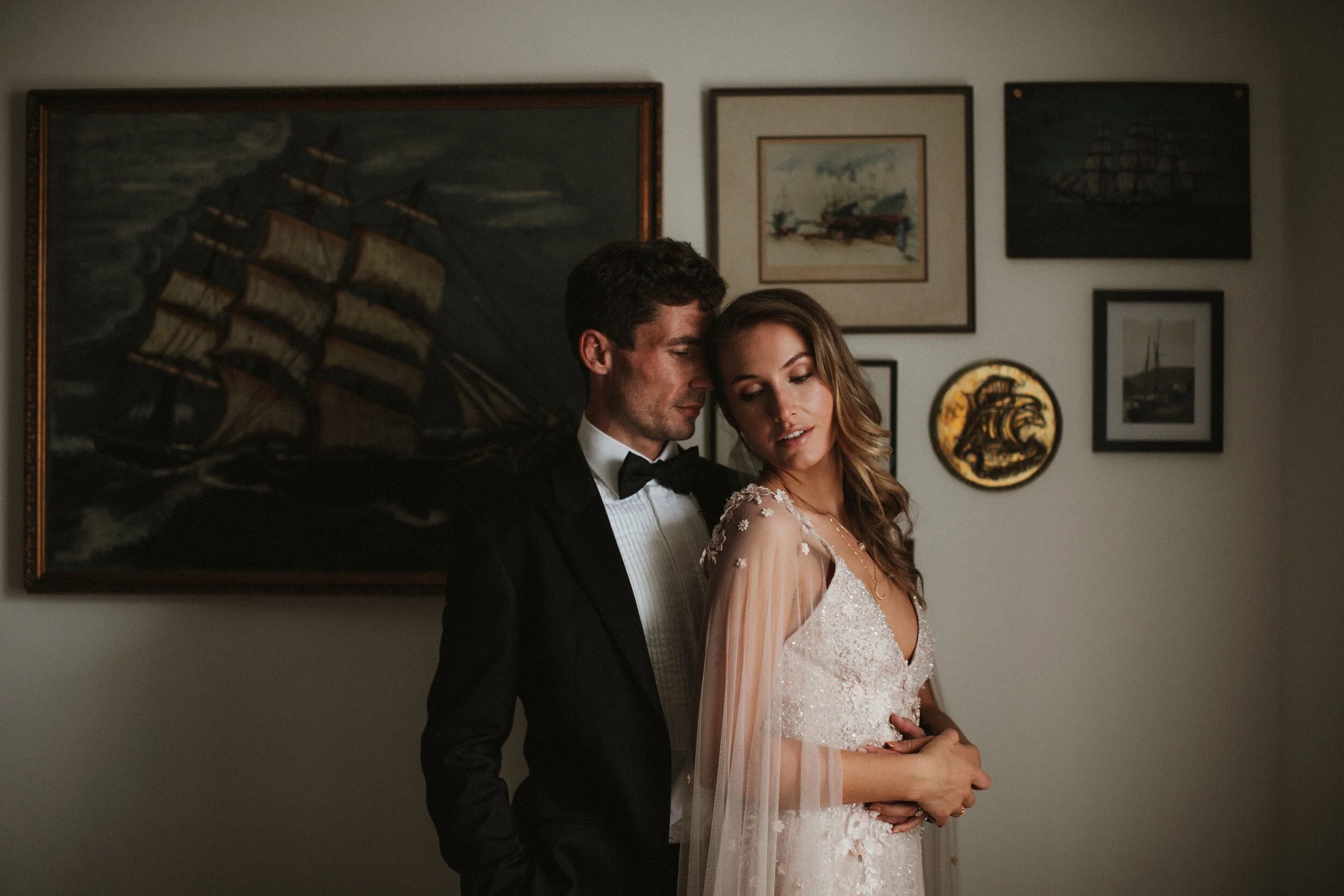 Male model Matt Sharman holds female model Lara wearing a black tuxedo, white shirt and black bow tie for Fern Godfrey Weddings