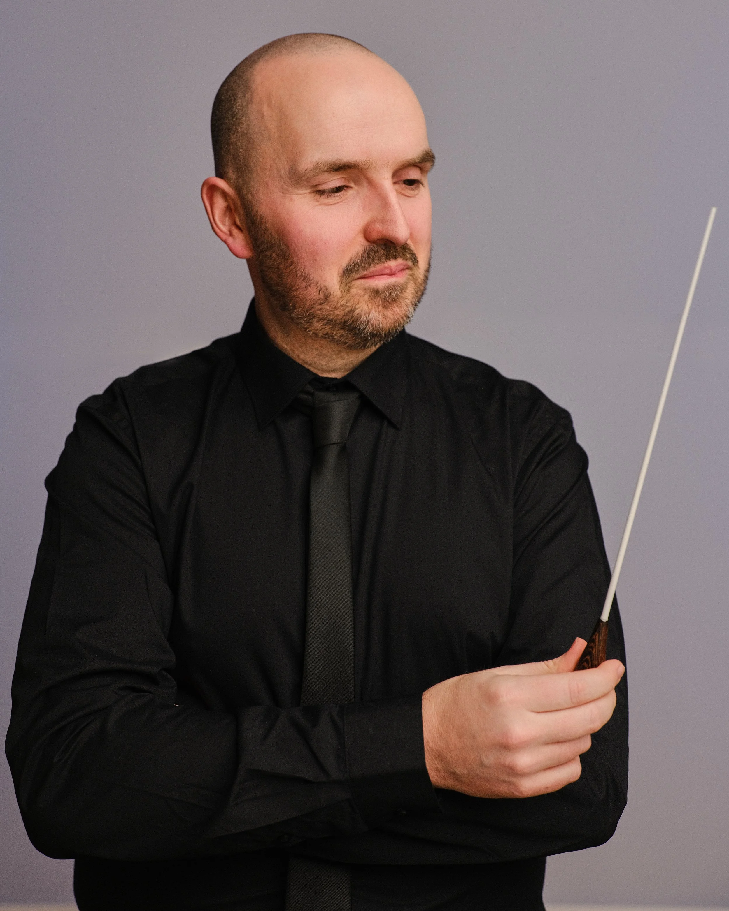 Paul Emmett holding a conducting baton