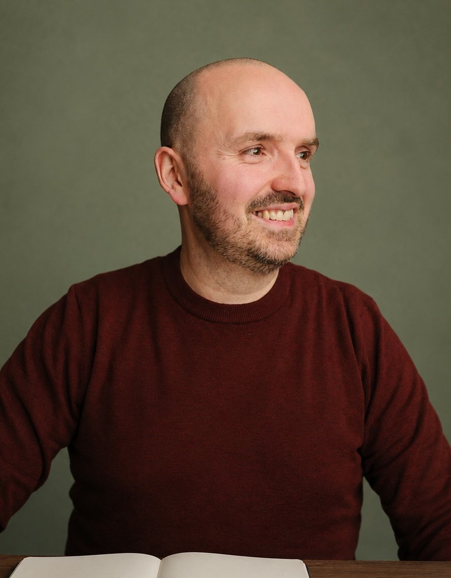 Portrait of Paul Emmett smiling, wearing a burgundy jumper