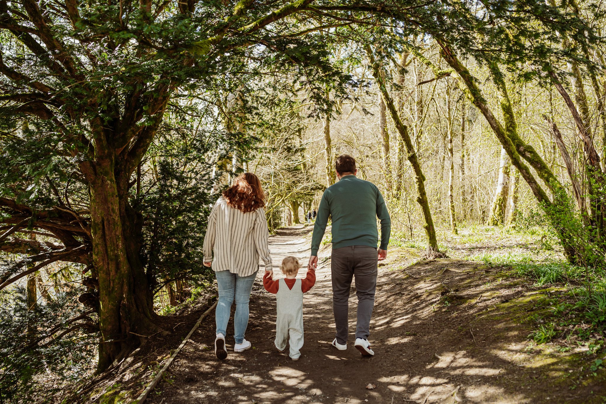 Family on a walk in the woodland with a toddler