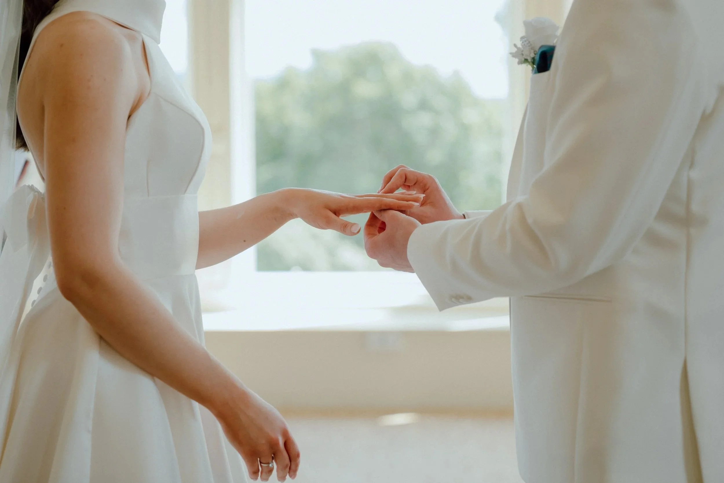 A close up of hands-Groom putting ring on bride finger by patrice little photography