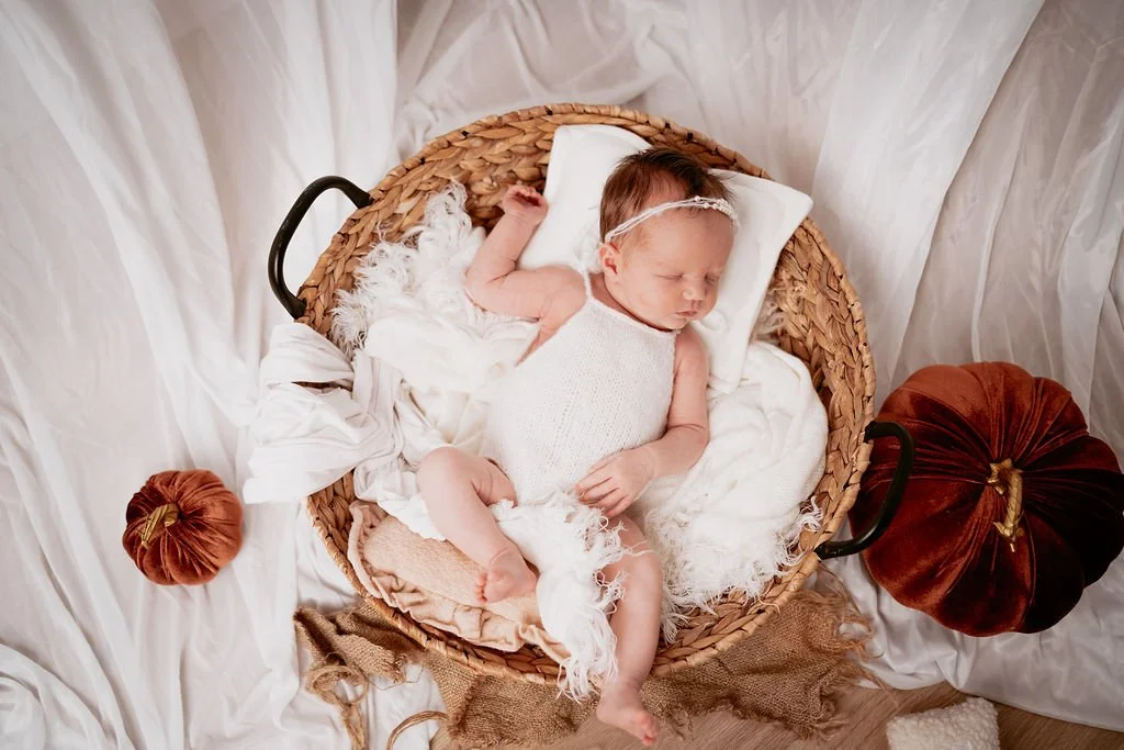 Sleeping newborn baby photographed in soft white and neutral tones during a newborn studio session in Perthshire.