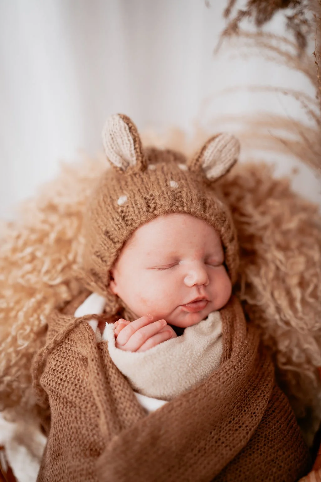 A newborn sleeping baby captured in natural light during a newborn photoshood