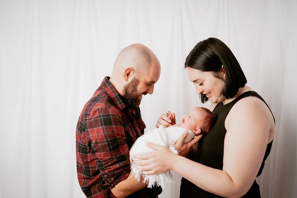 Parents and their newborn baby during a family newborn photography session in Perthshire, Scotland.