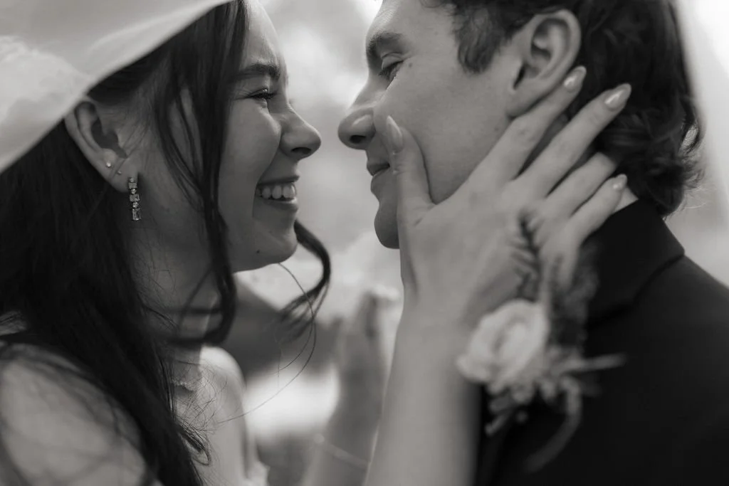 Candid black-and-white portrait of a newly married couple laughing together during their Atholl Palace wedding.