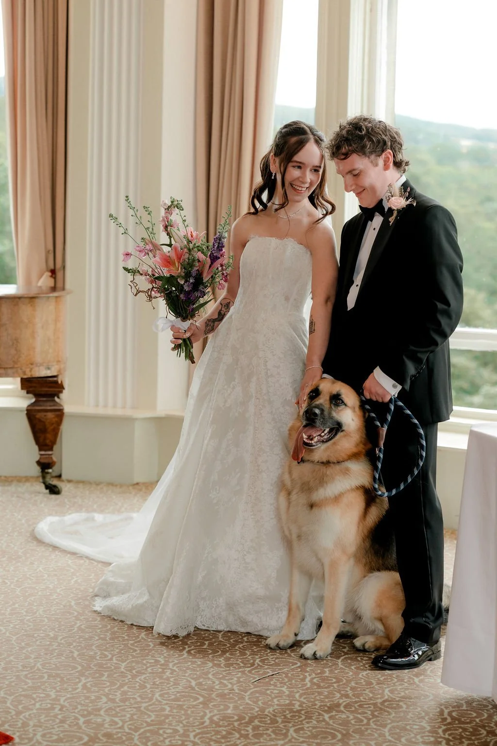 Bride and groom smiling beside their German Shepherd after their intimate Atholl Palace wedding ceremony.