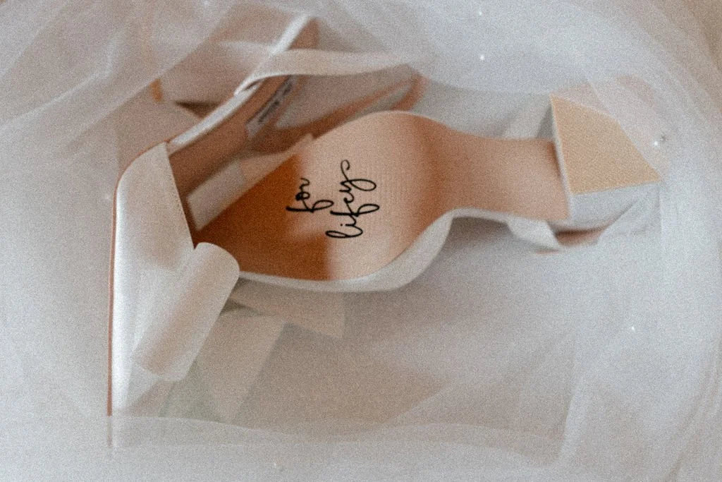 Bridal accessories and white wedding shoes prepared for a Piperdam Resort wedding