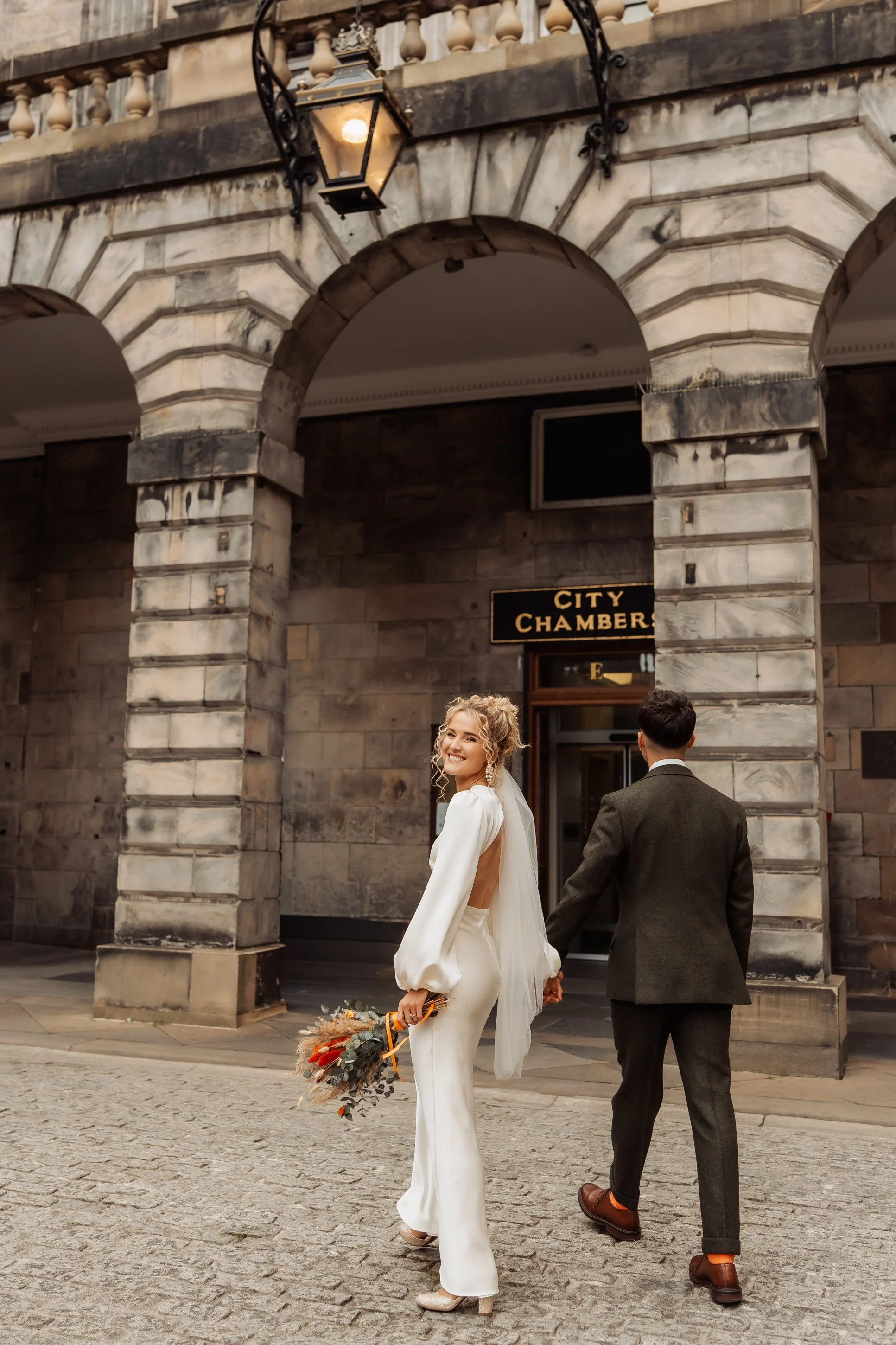 newly married couple outside Edinburgh City Chambers on the Royal Mile