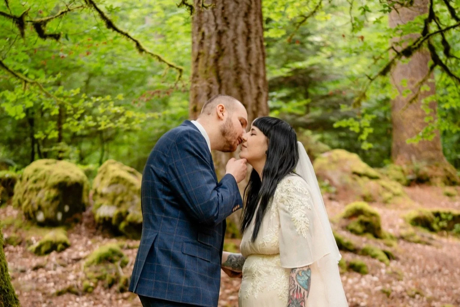 Couple kissing other during their intimate woodland elopement at The Hermitage, Dunkeld, Scotland.