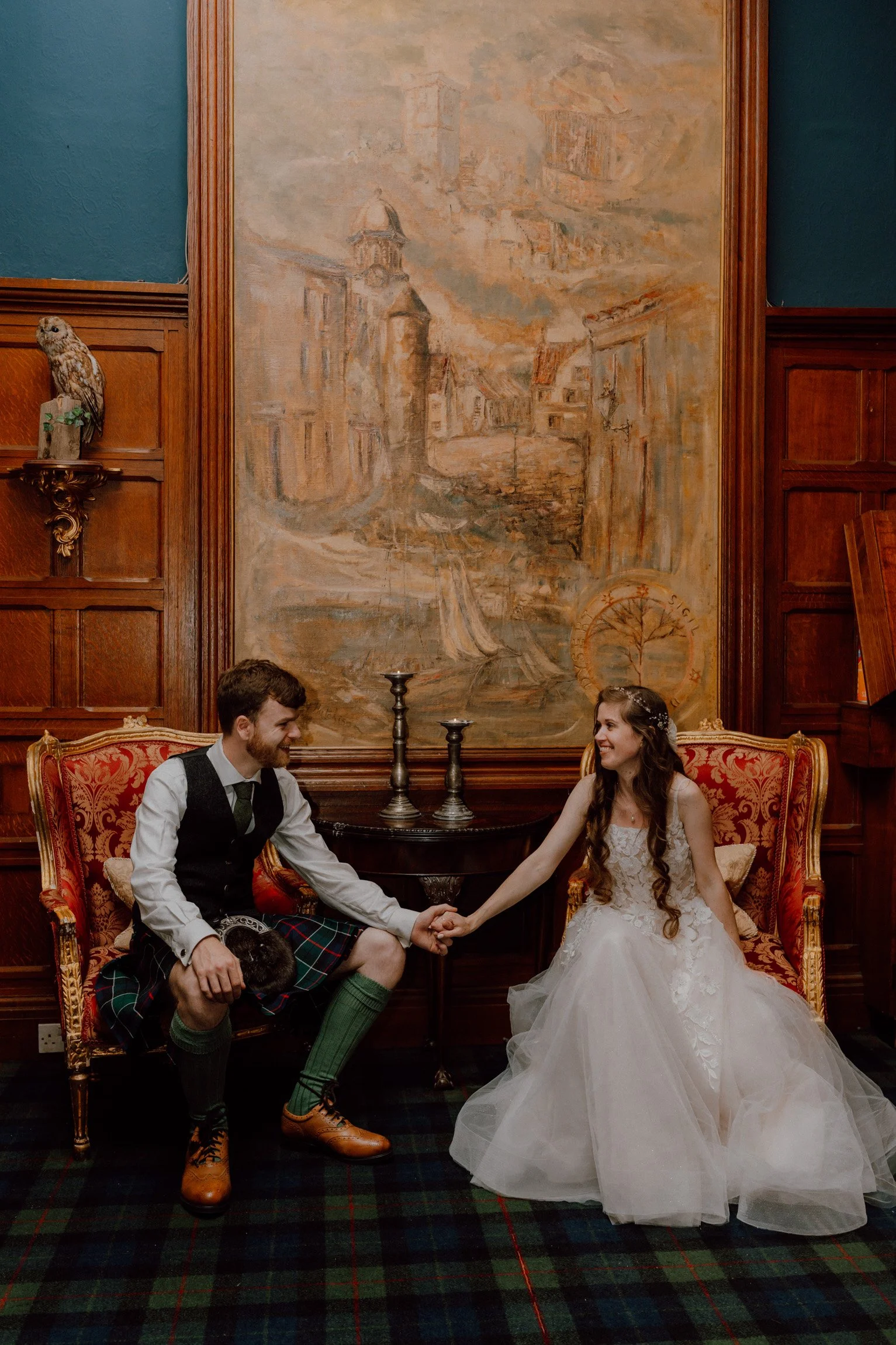 Bride and groom holding hands inside the elegant drawing room at Oswald House wedding venue.