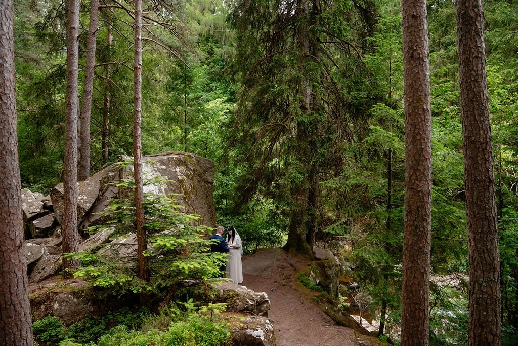 Couple celebrating their elopement at The Hermitage in Perthshire, Scotland, with a peaceful forest setting and dramatic natural rock formations.