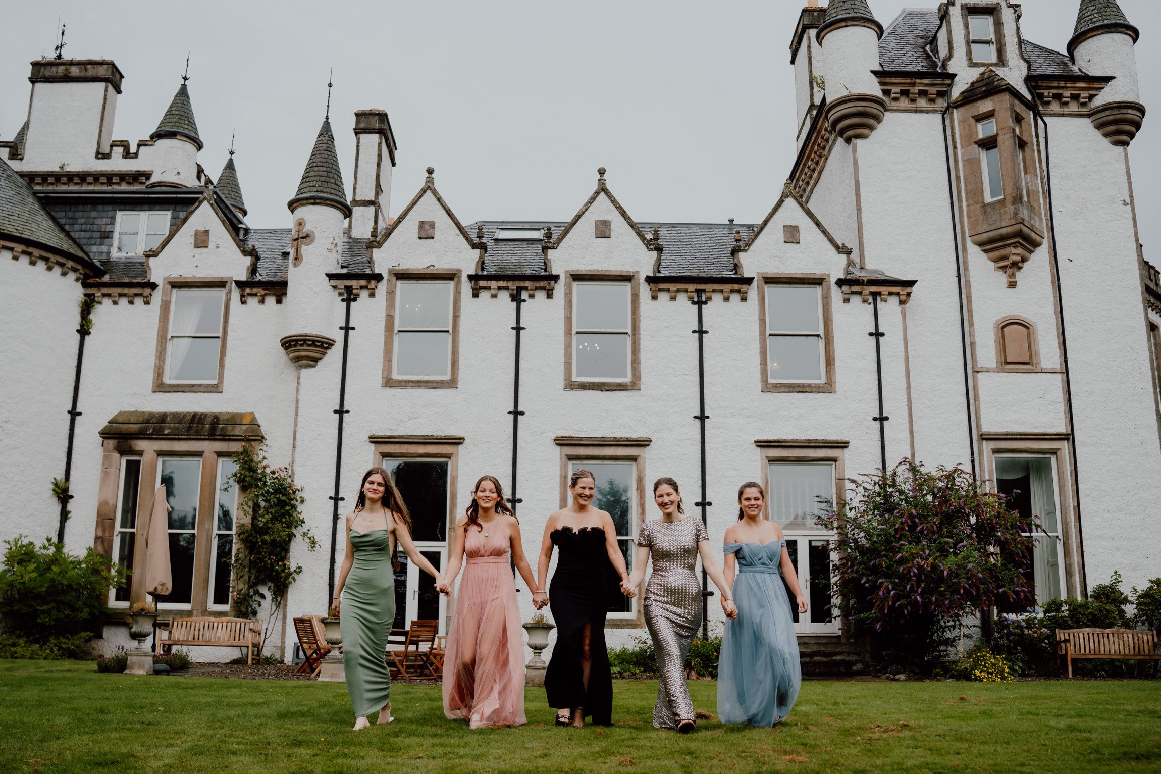 Two families gathered for a stylish family reunion outside Dalnaglar Castle in Glenshee, Scotland.