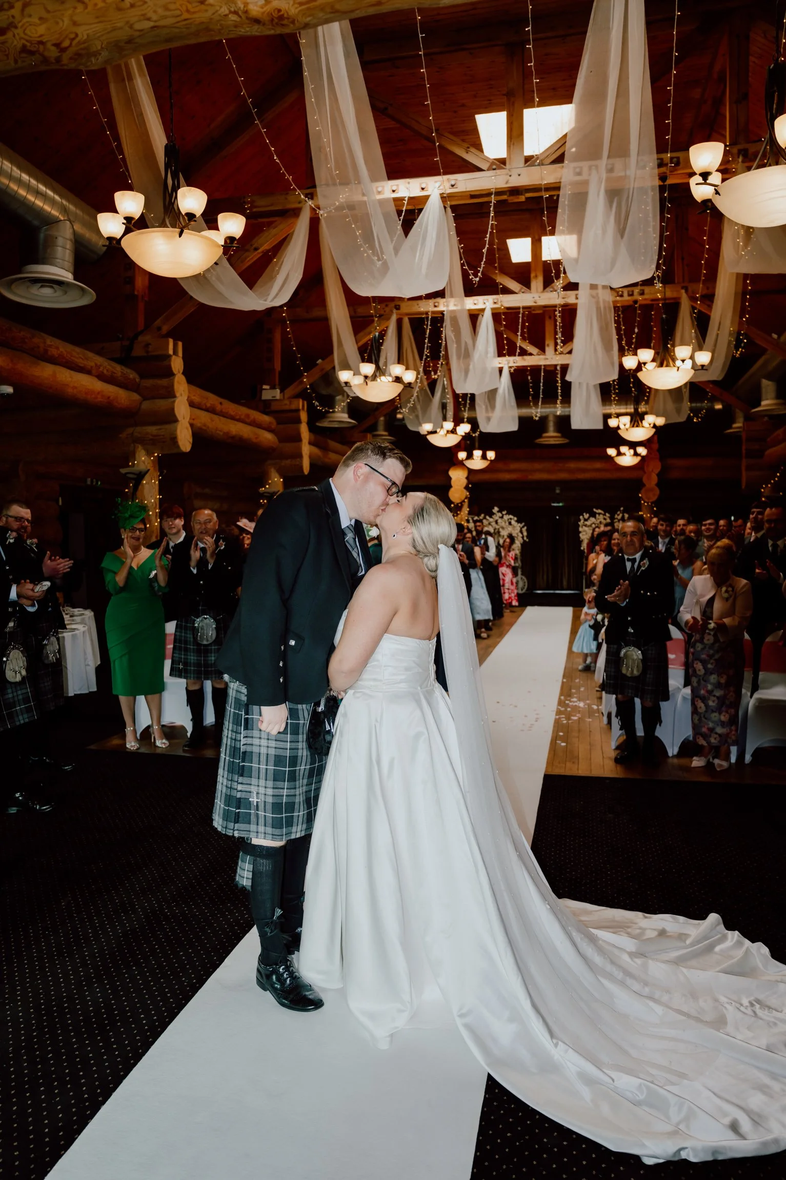 Married Couple having first kiss around rustic Piperdam ceremony space photographed by patrice little photography