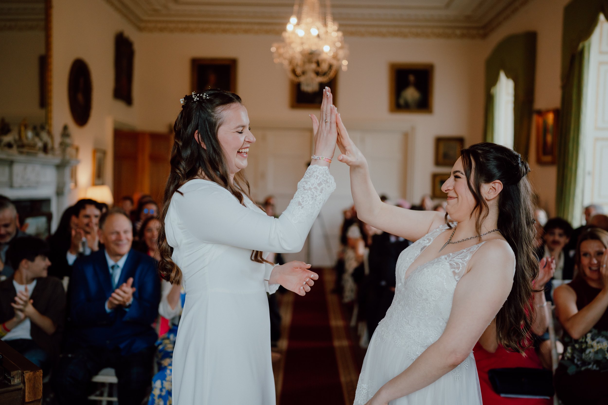 Emotional bridesmaid reactions during a luxury same-sex wedding at Megginch Castle. Documentary wedding photography in Perthshire, Scotland.