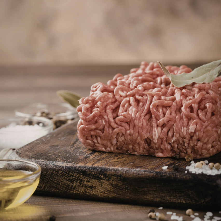Raw ground beef on a wood cutting board