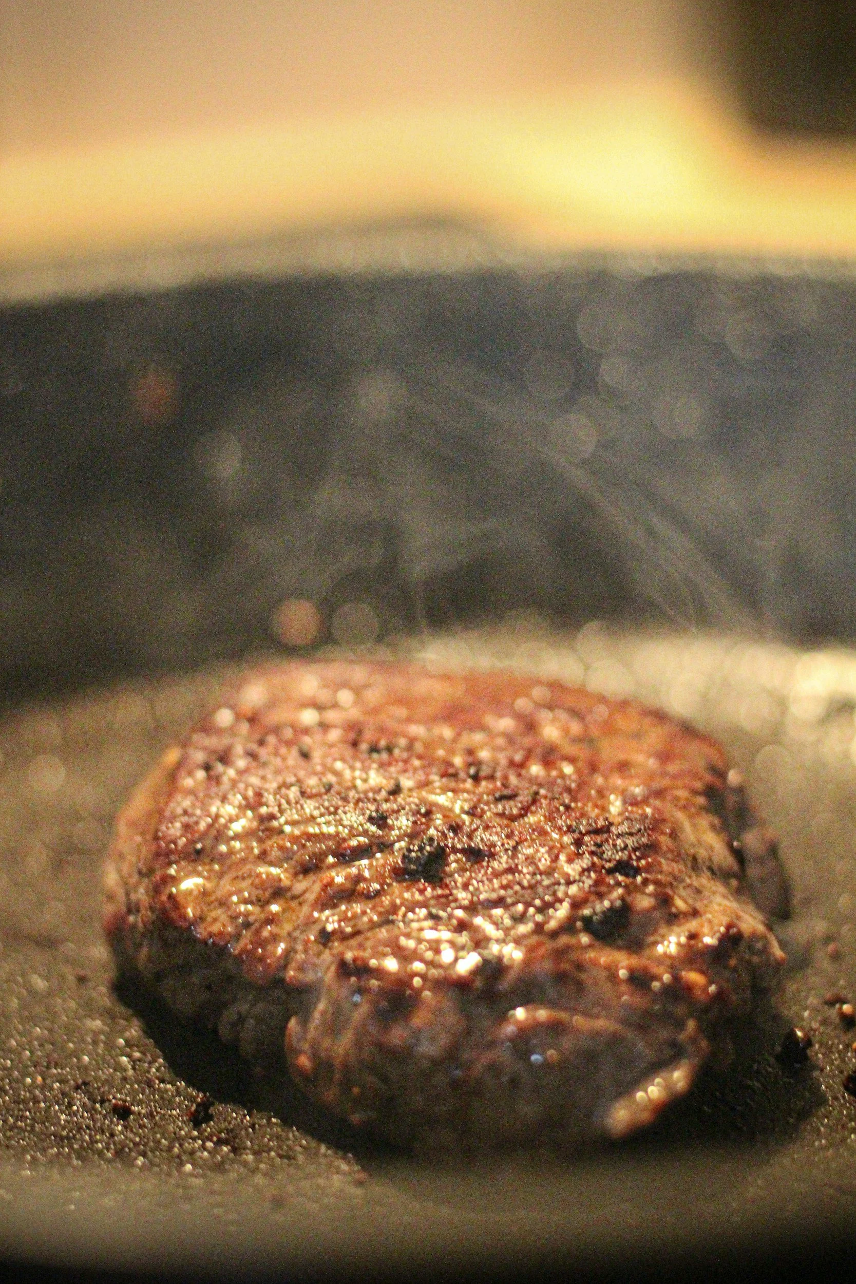 A steak cooking on cast iron