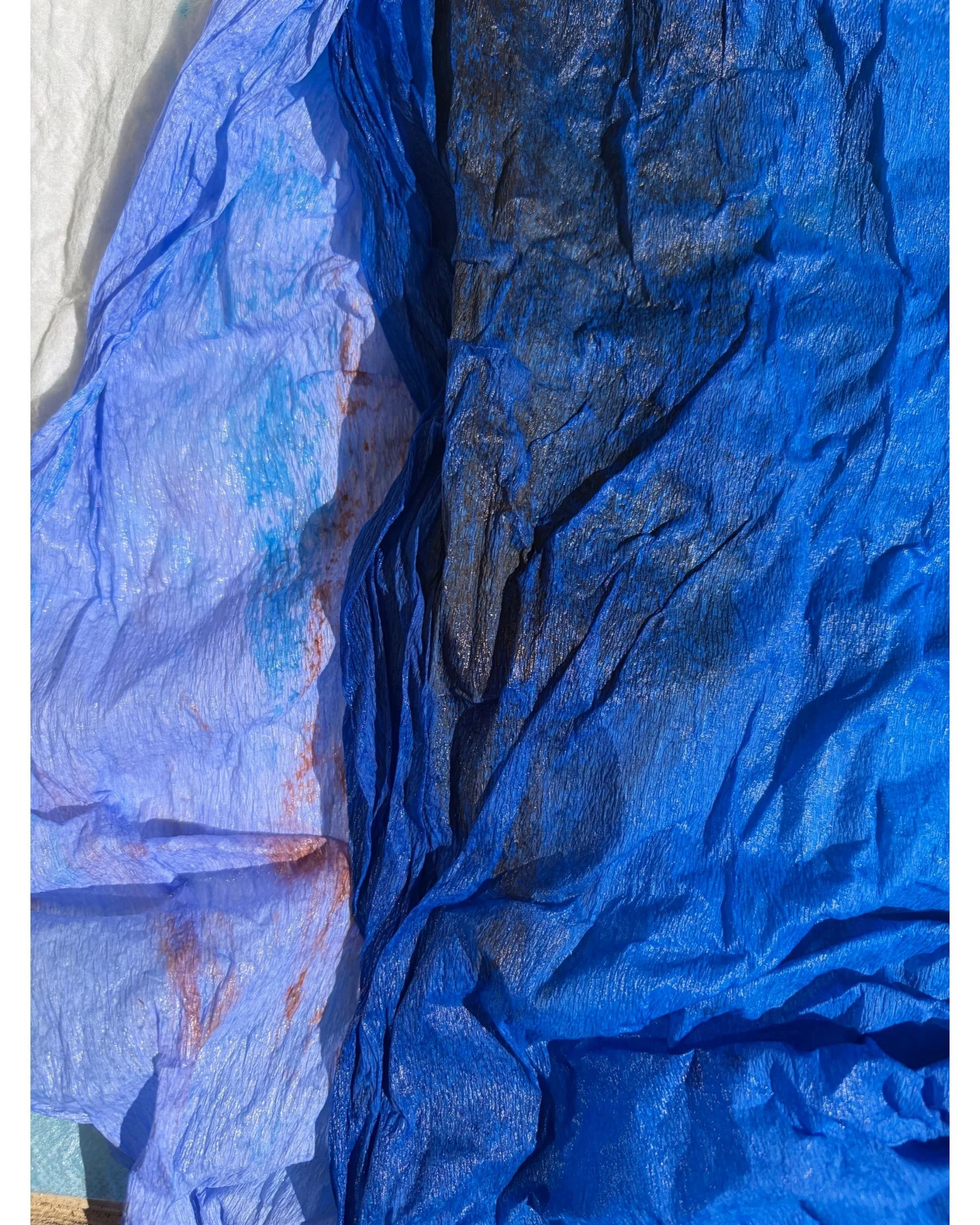 Textured hand-dyed crepe paper in deep blue and indigo tones with organic variations, created through experimental dyeing by Emmeli Kimhi