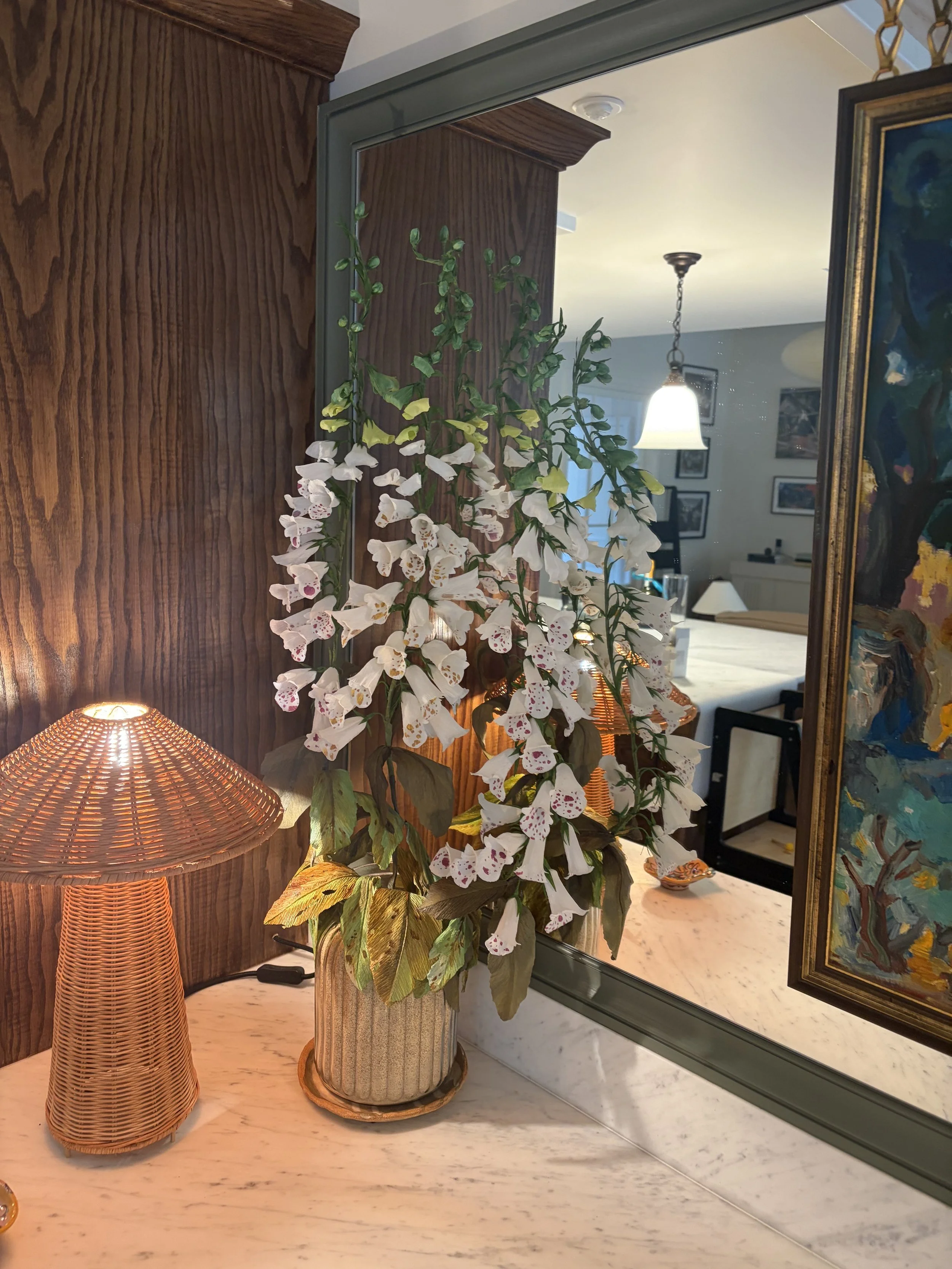 Hand-painted paper foxglove arrangement by Emmeli Kimhi displayed in a ceramic vase at Studio Tolstoy, reflected in a mirror
