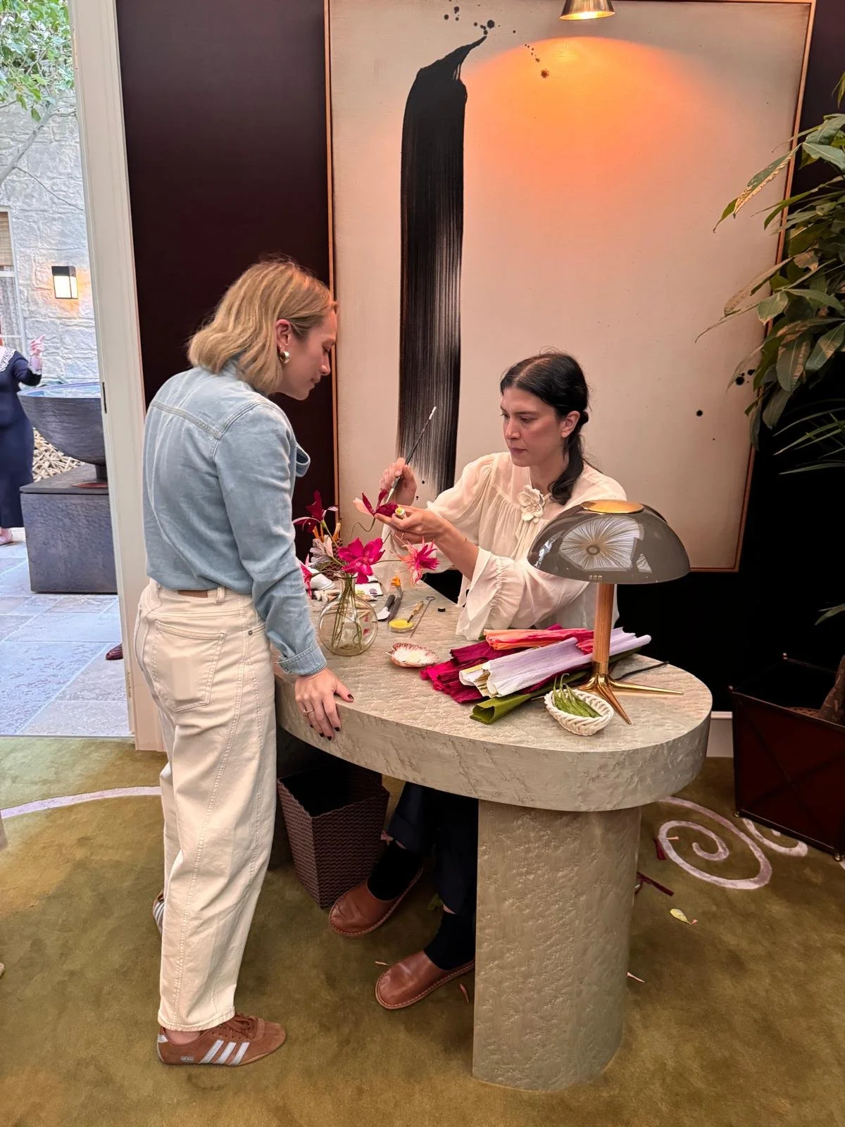 Emmeli Kimhi demonstrating live paper flower making to Tiffany Duggan of Studio Duggan during the breakfast event at The SpeakEasy Salon, WOW!house 2026.