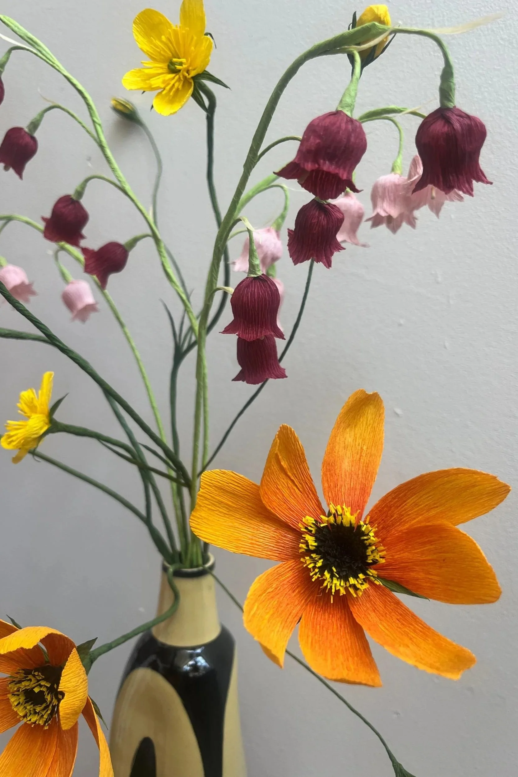 Handcrafted mixed wildflower paper bouquet in warm sunset tones with orange, yellow and burgundy flowers by Emmeli Kimhi