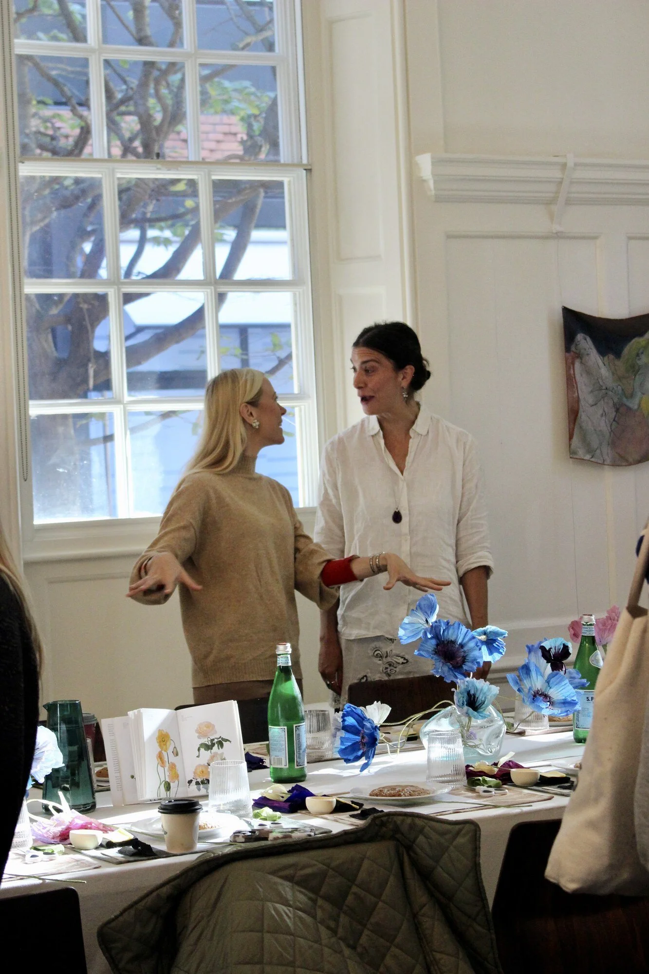 Mid-workshop table with paper poppies, handouts and drinks at Blewcoat
