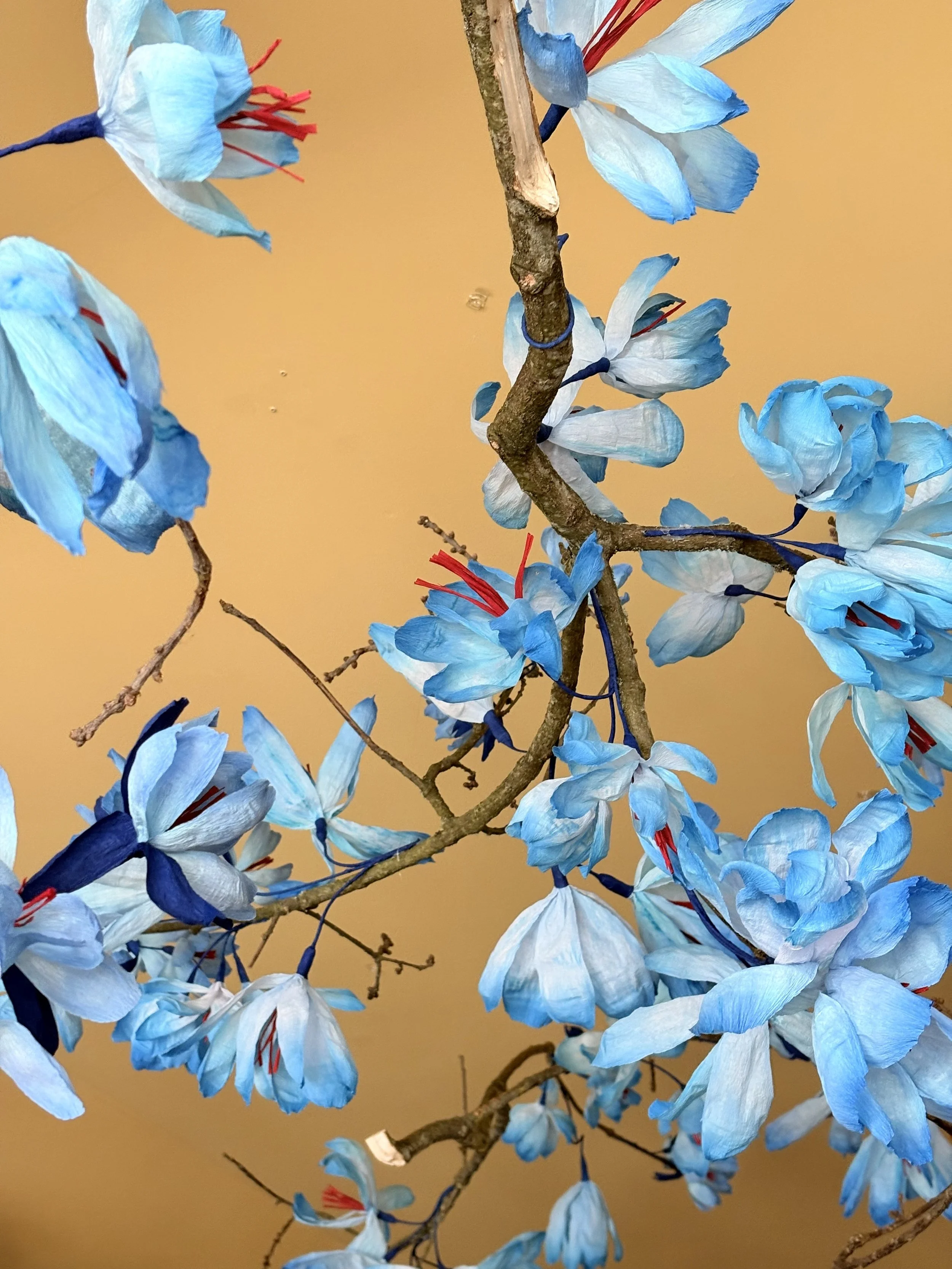 magnolia branch installation by Emmeli Kimhi suspended from the ceiling in a luxury retail interior at And Objects, London