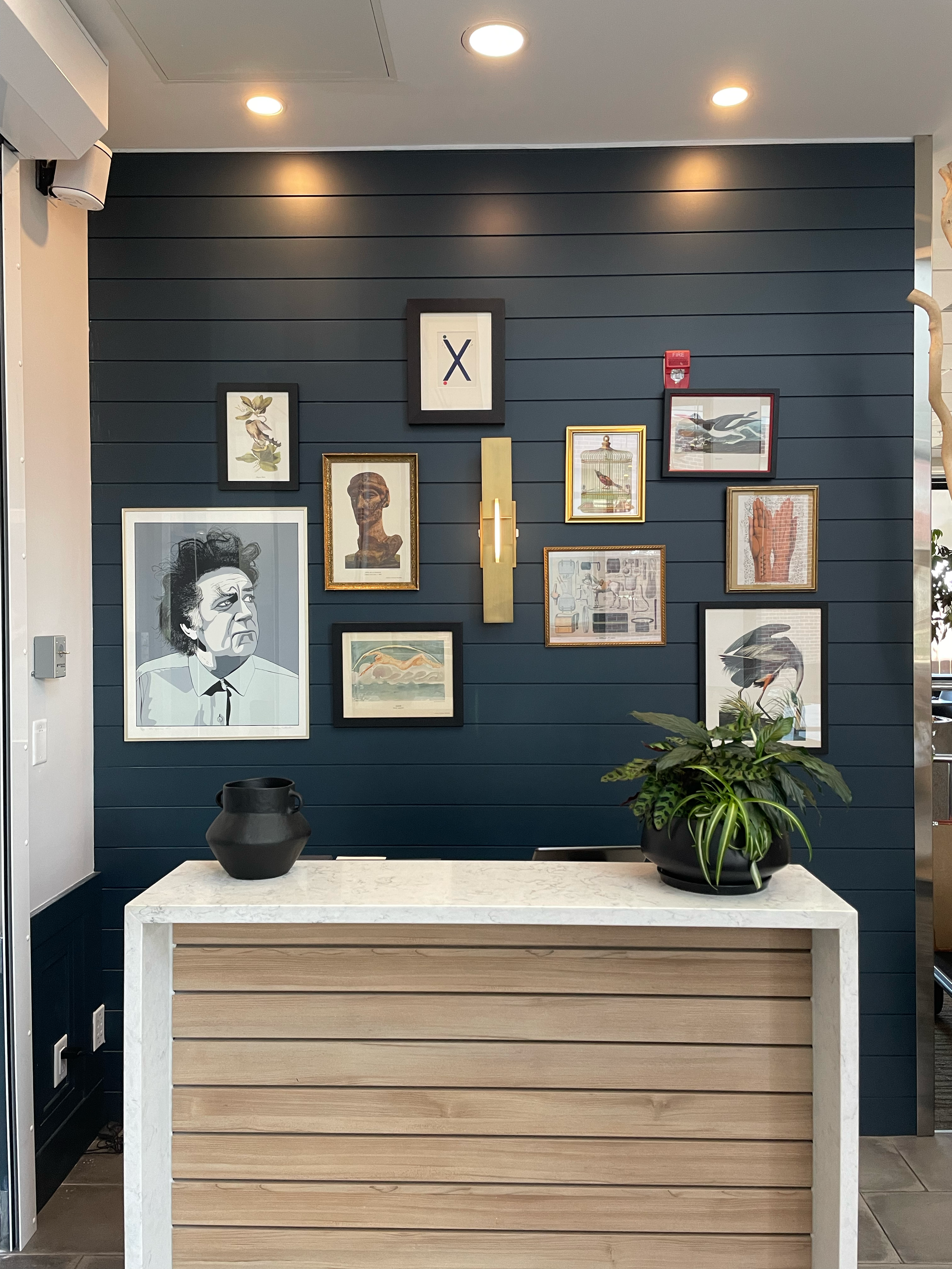 Recently added gallery wall to the hostess desk