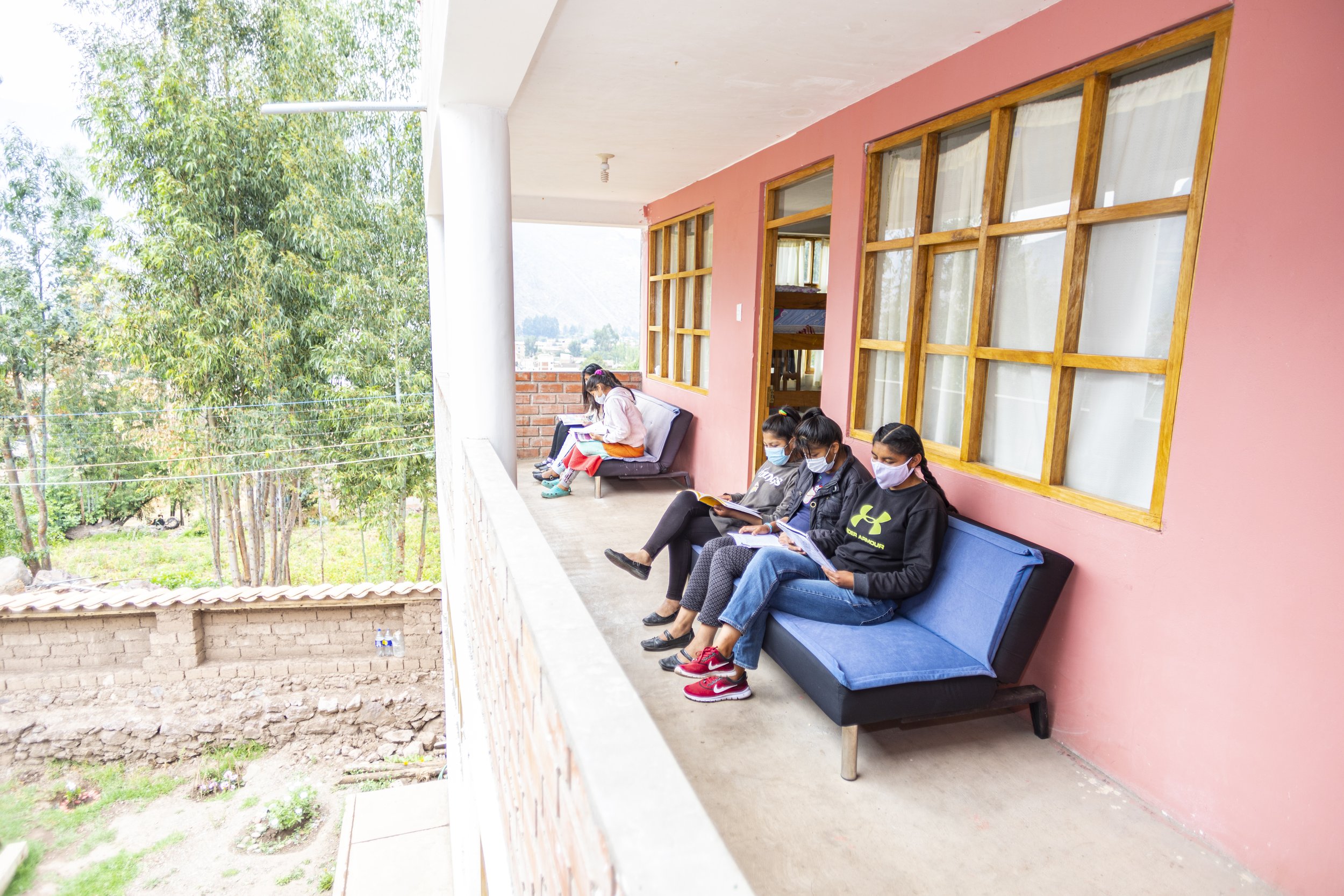 girls sitting outside the dorm at the Sacred Valley Project in Peru.jpg